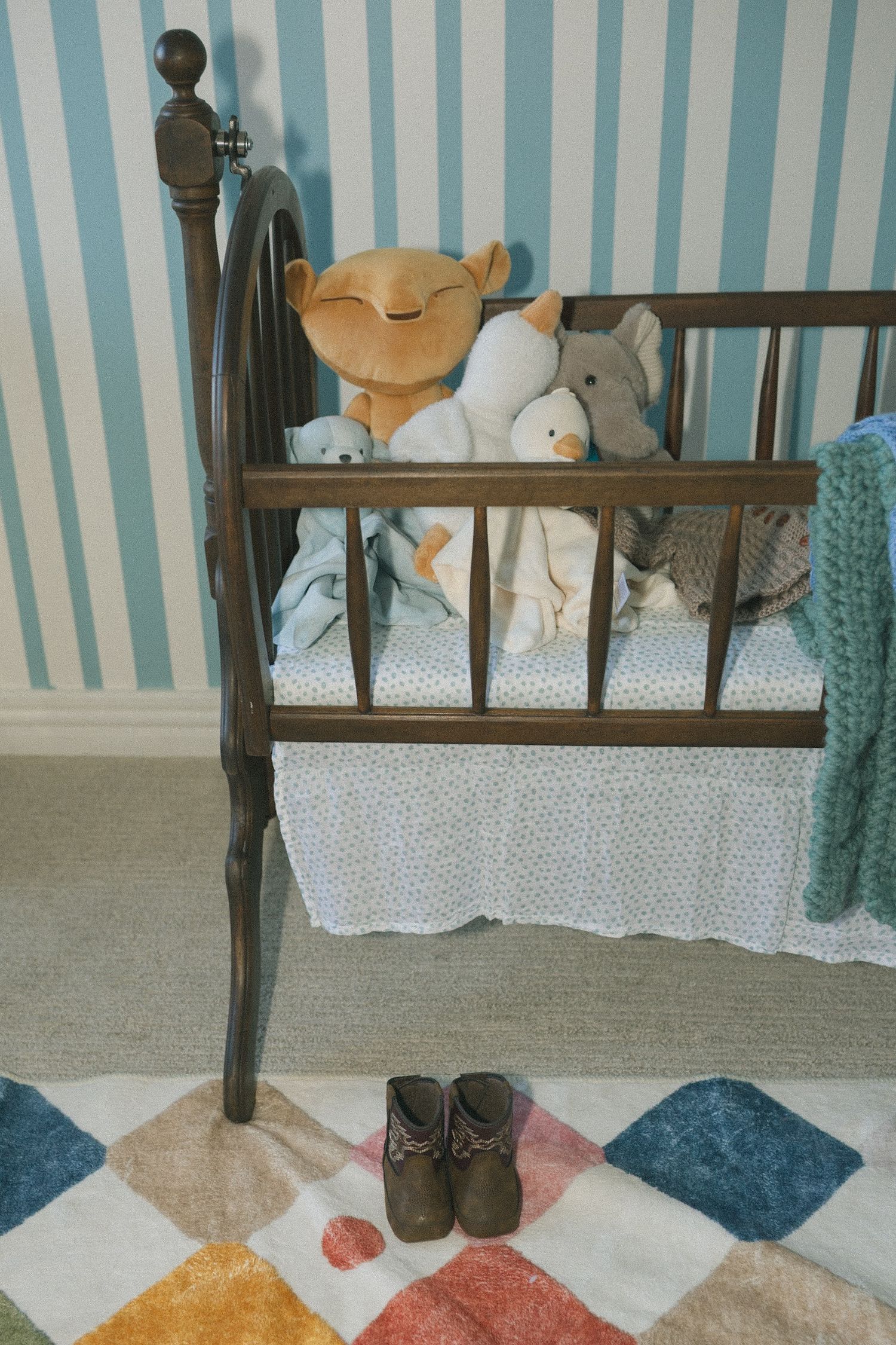 A series of four photos showing black boots standing on a colorful geometric rug against a blue striped wall with plush toys.