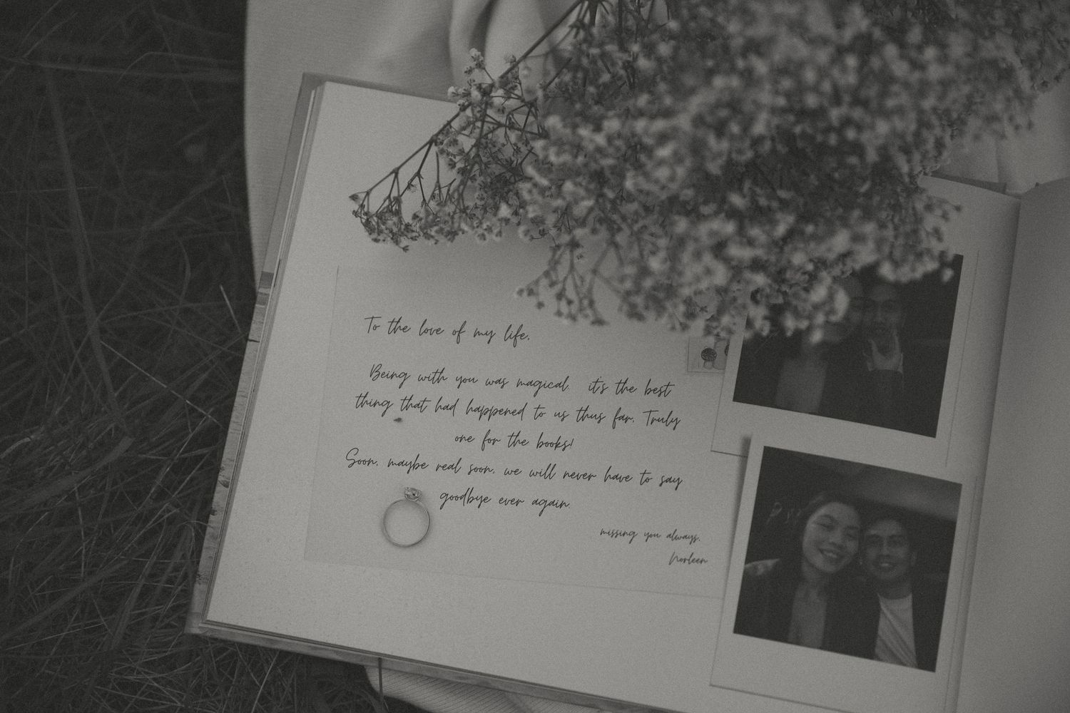 Wedding invitation with handwritten text and dried flowers displayed with a photograph.