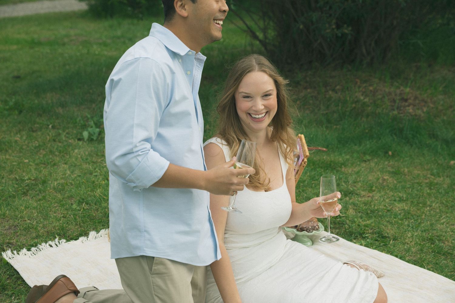 A couple enjoying a cheerful moment together outdoors on a sunny day.
