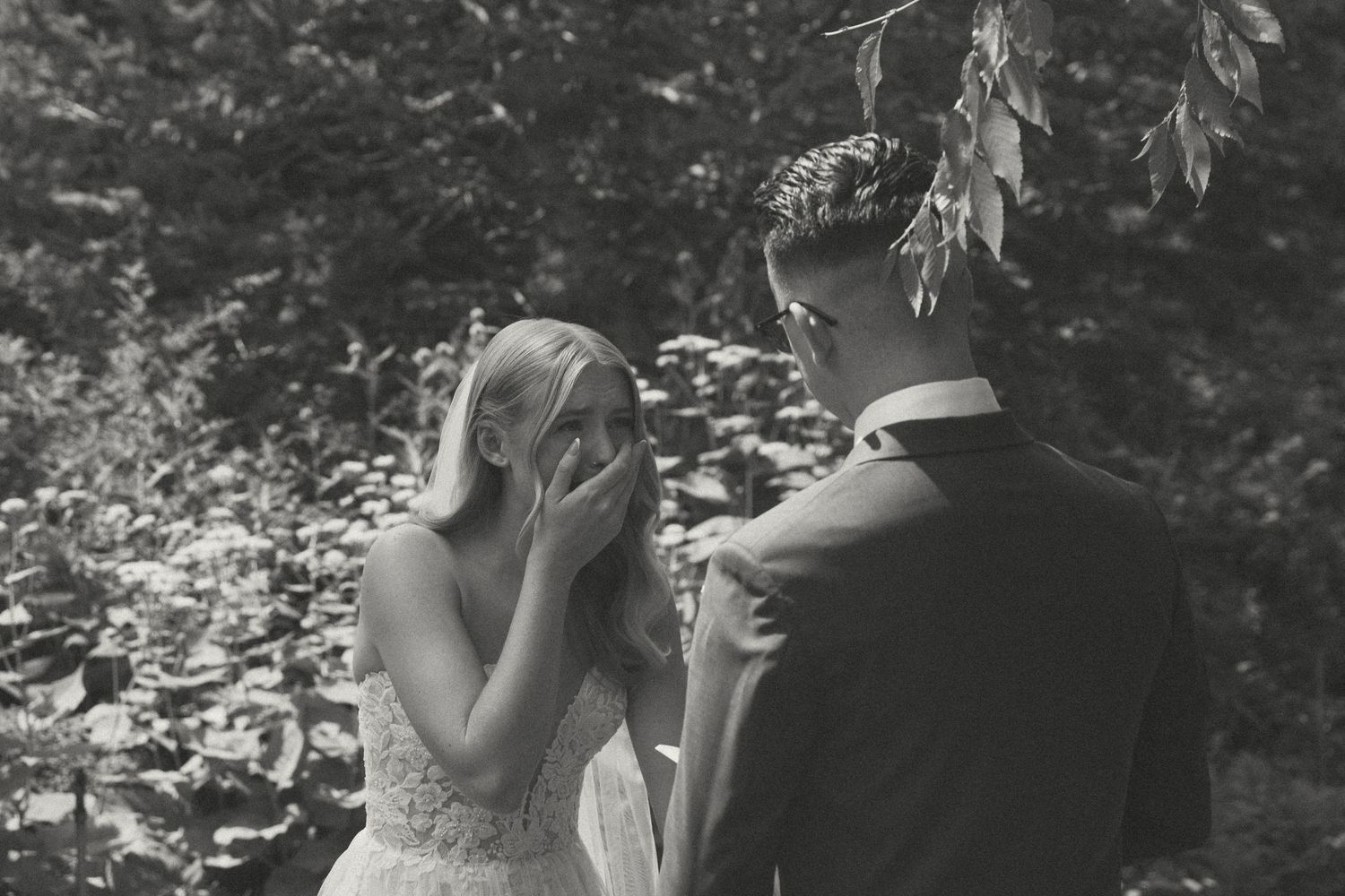 A black and white capture of personal vows moment in a garden.