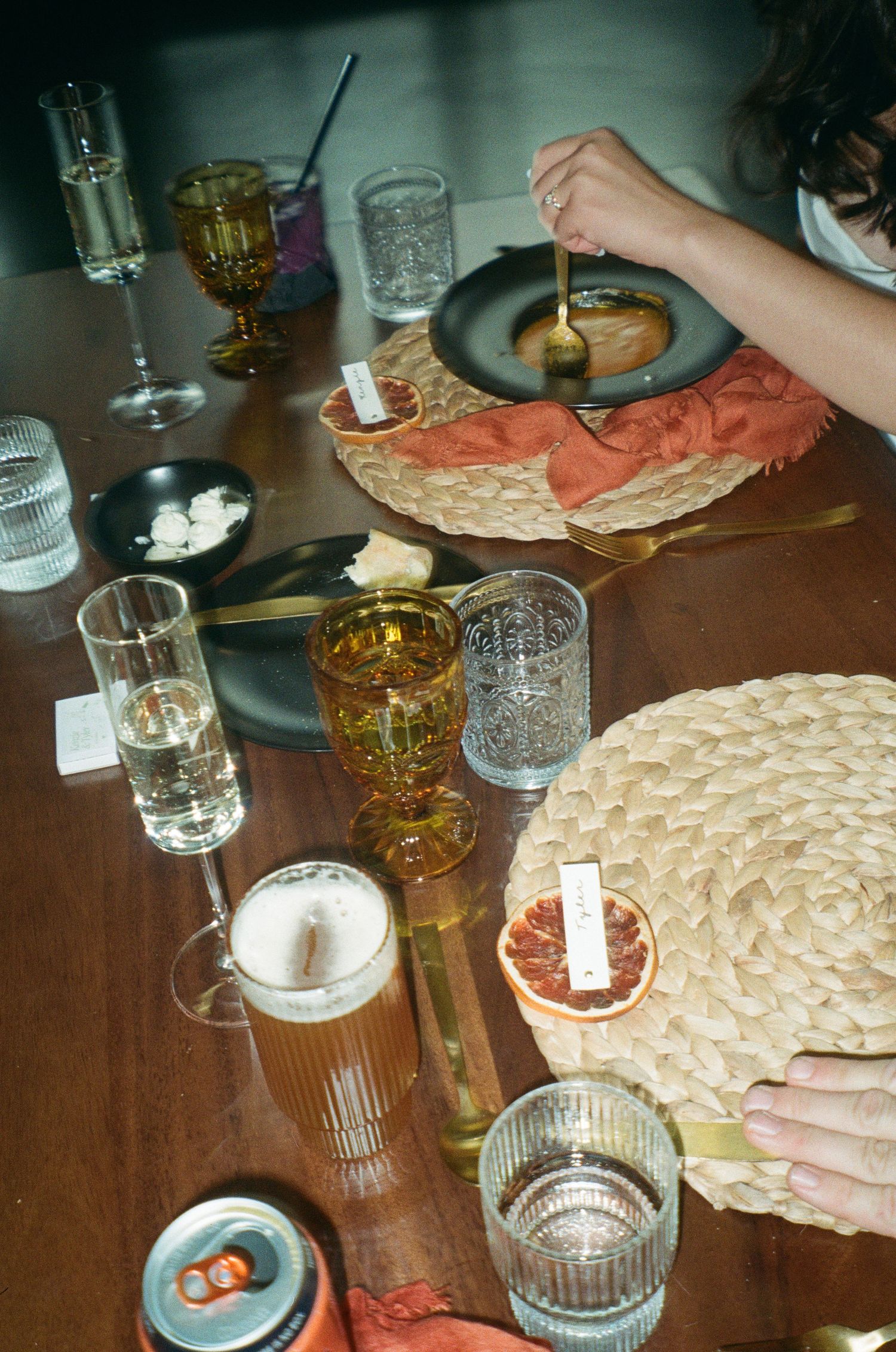 Table setting with drinks and appetizers at a casual gathering.