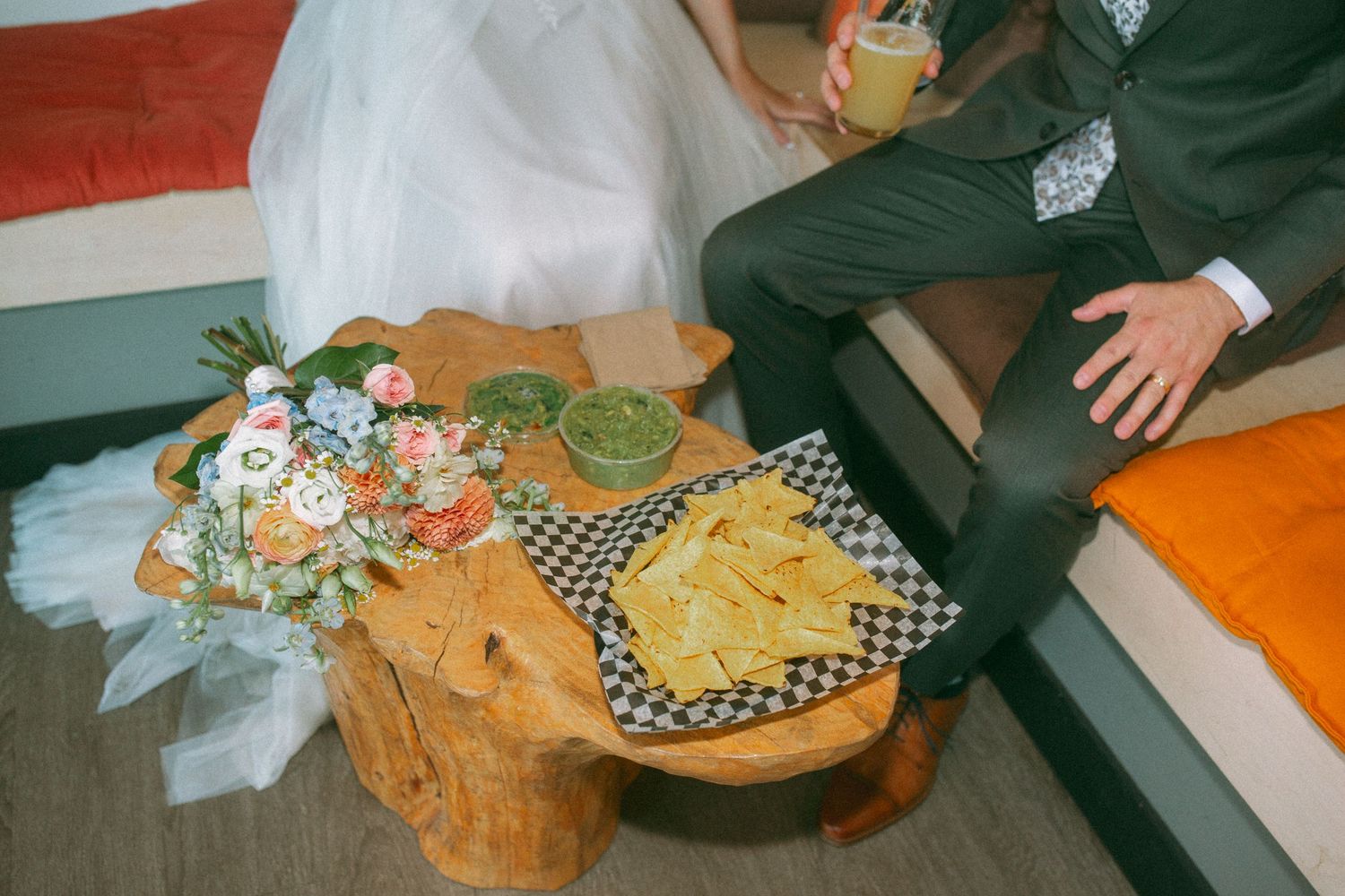 Wedding reception table with casual snacks and checkered cloth detail.