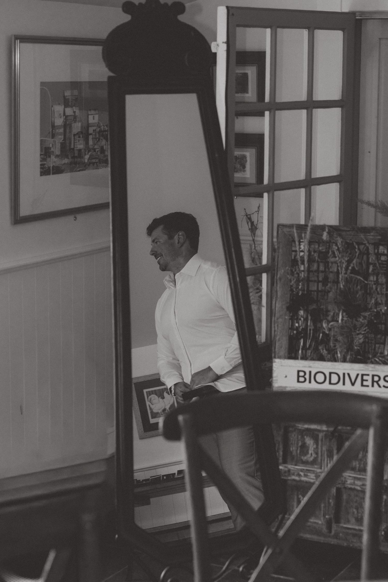 Black and white photo of a workspace with biodiversity signage visible in the background.