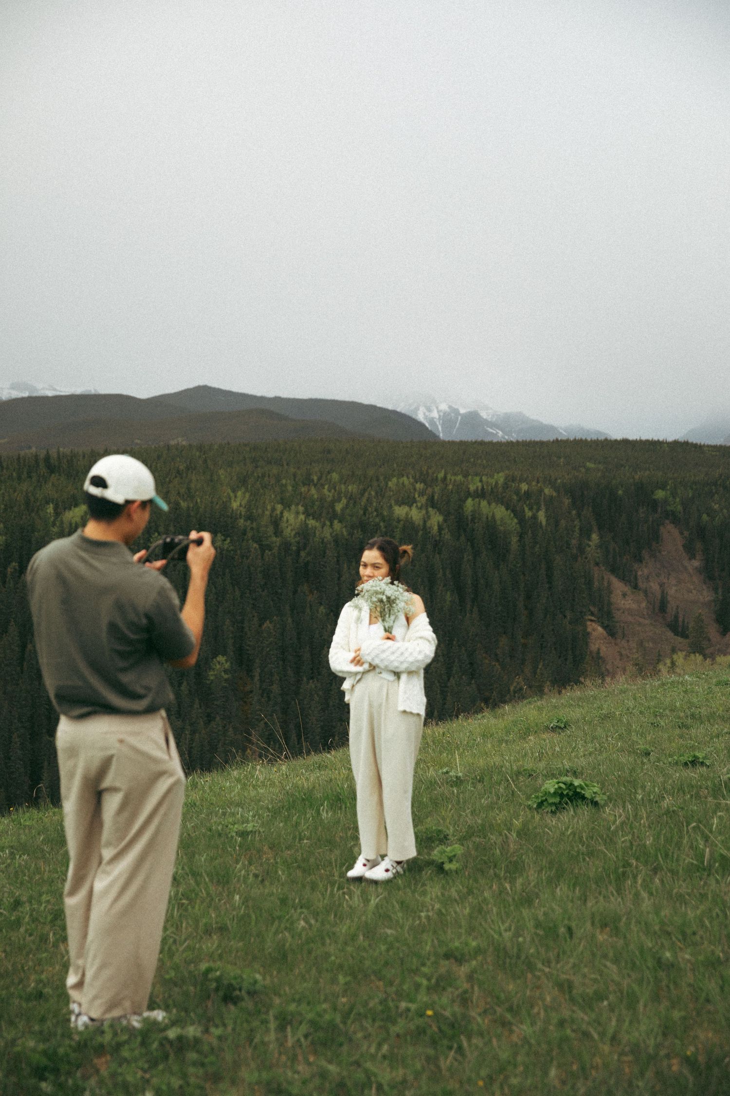 Photographer capturing a portrait on a scenic mountain overlook.