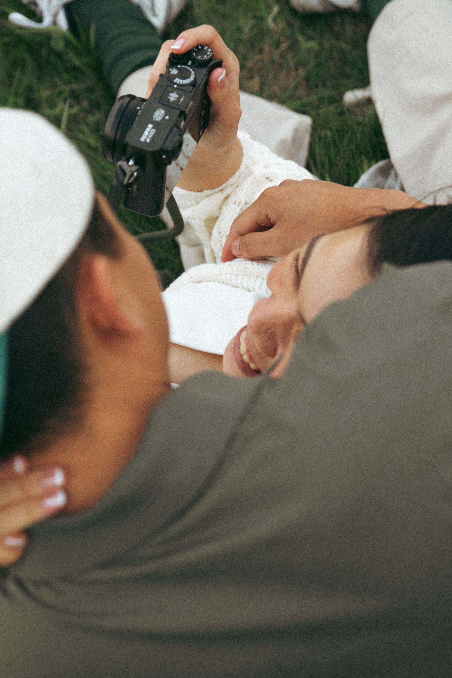 Someone taking notes while another person holds a camera during an outdoor photoshoot.