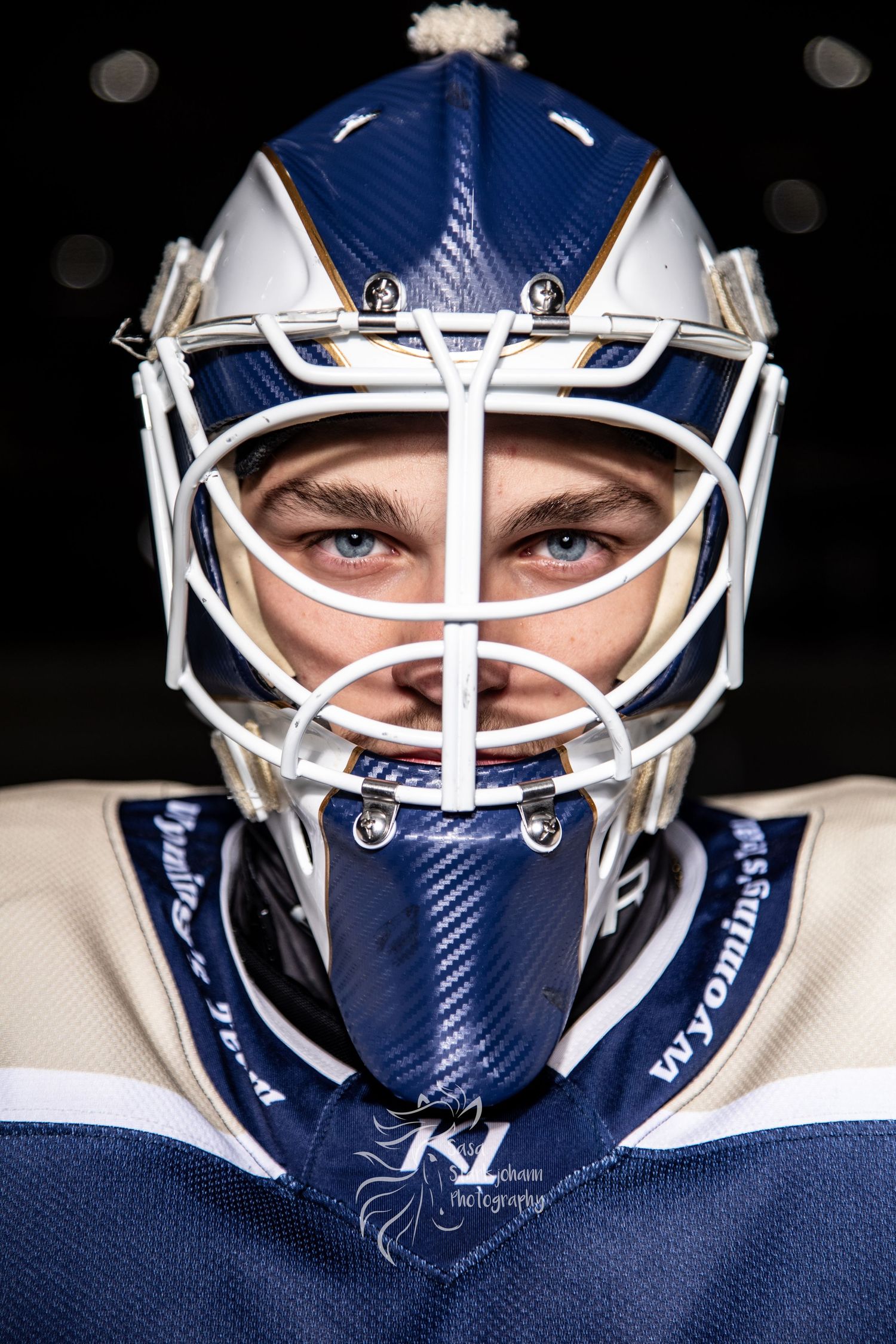 A close-up series of a hockey goalie mask in blue and white colors against a dark background.