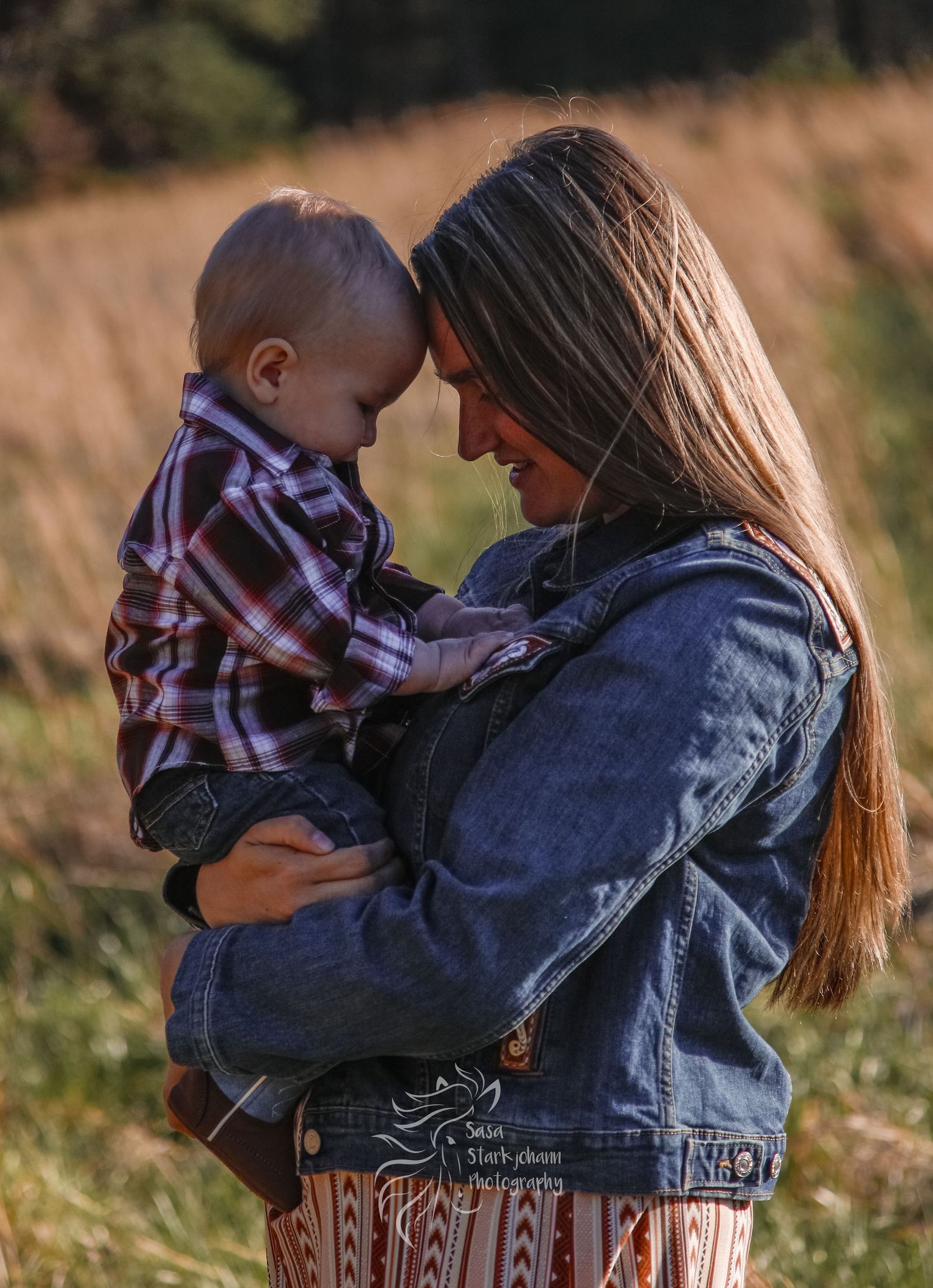 A tender moment captured between parent and child in an autumn field.