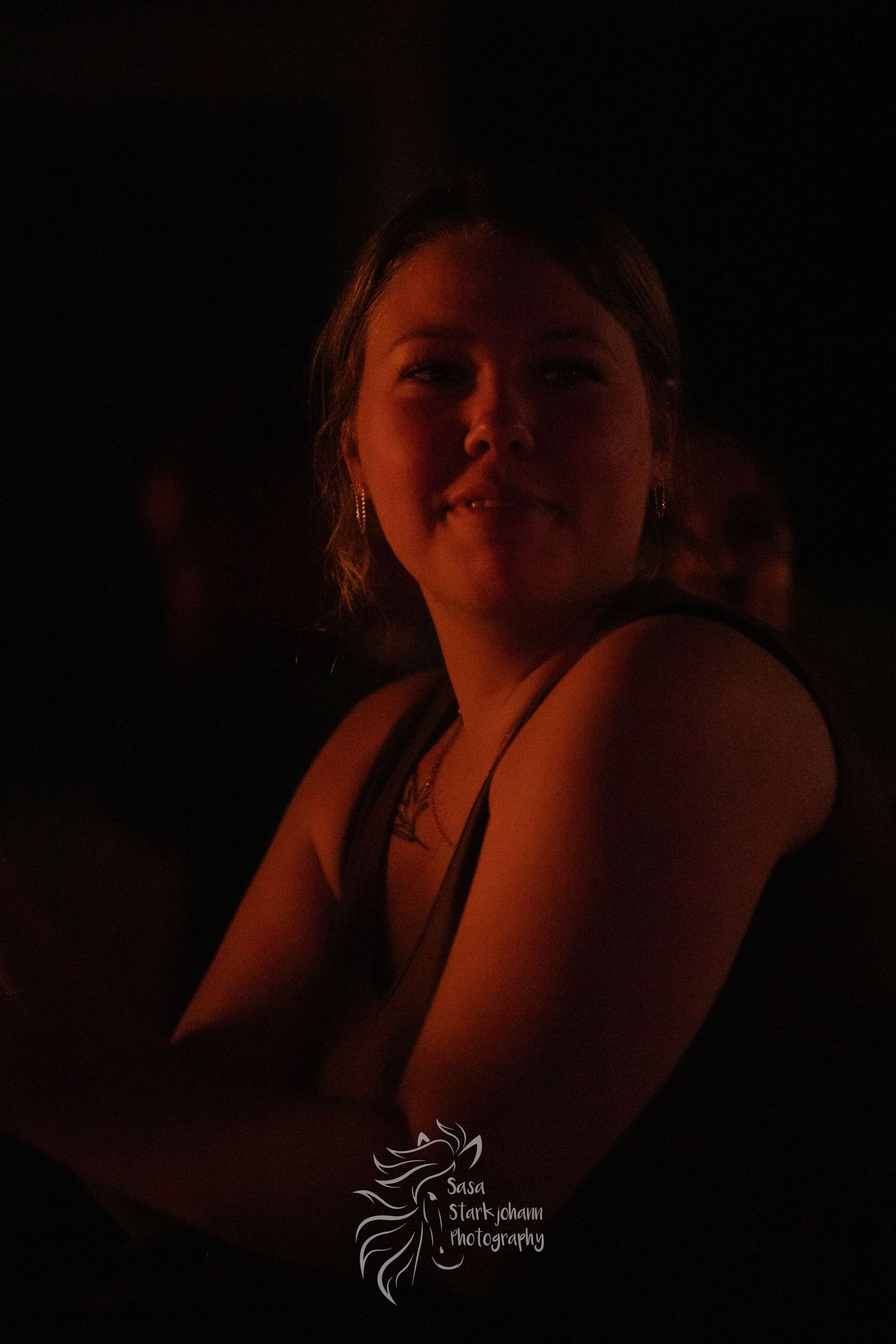 A candlelit portrait showing a warm ambiance in dark atmospheric lighting.