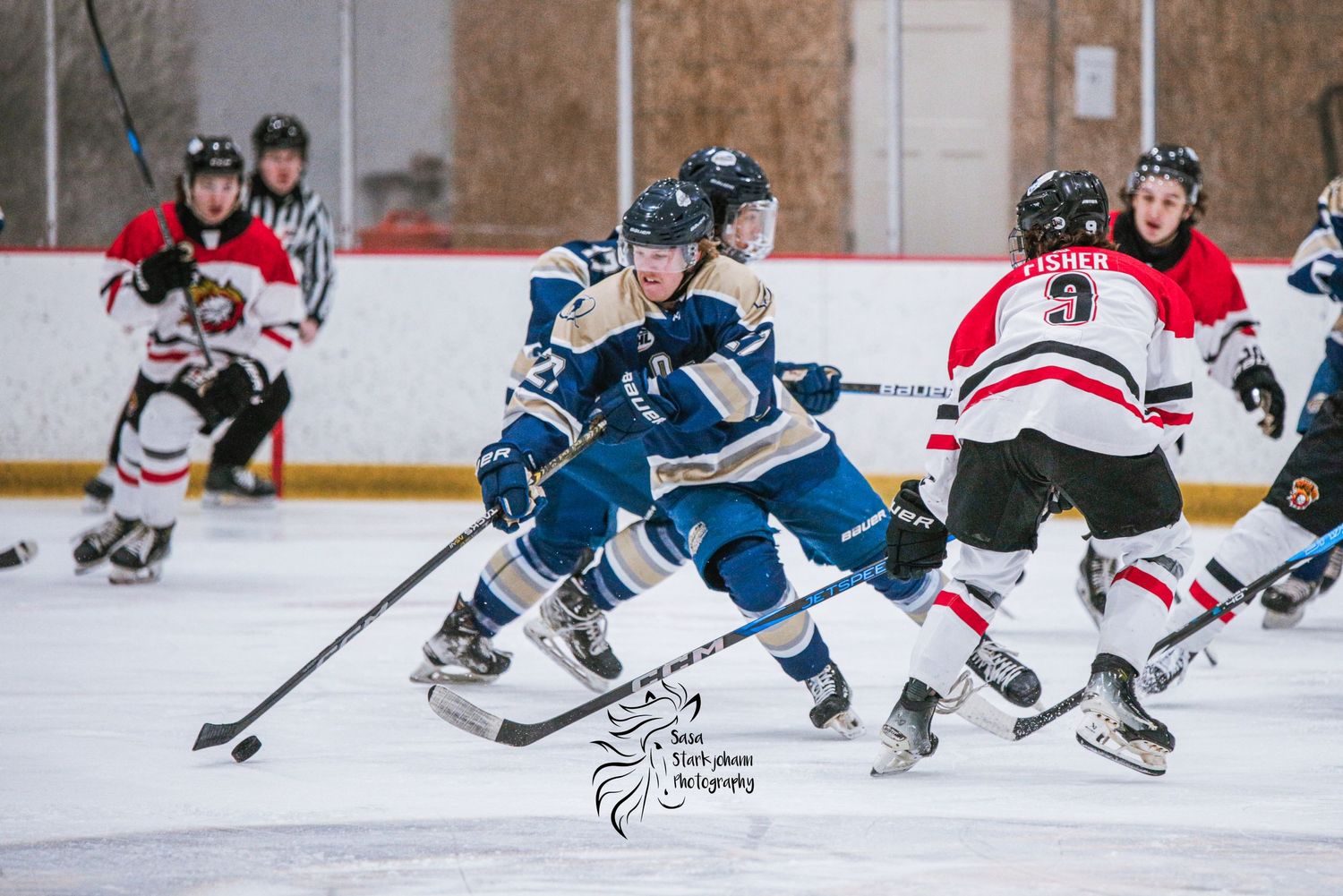 Hockey players from opposing teams compete for puck control during intense game action.