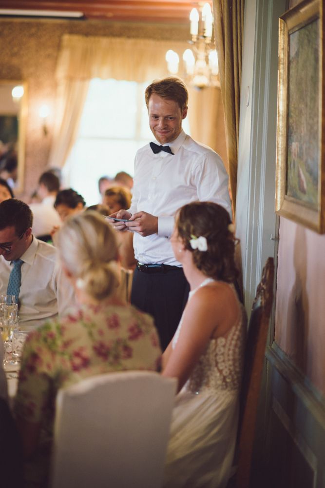 Server in formal attire attending to guests during an upscale dinner service.