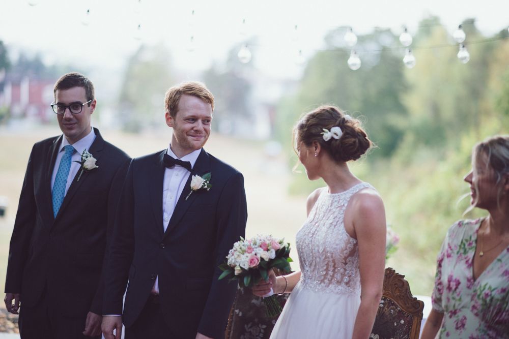 Wedding party gathered outdoors during a summer ceremony.