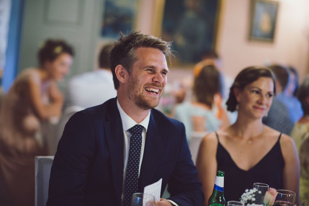 Candid moment captured during an elegant indoor wedding reception.