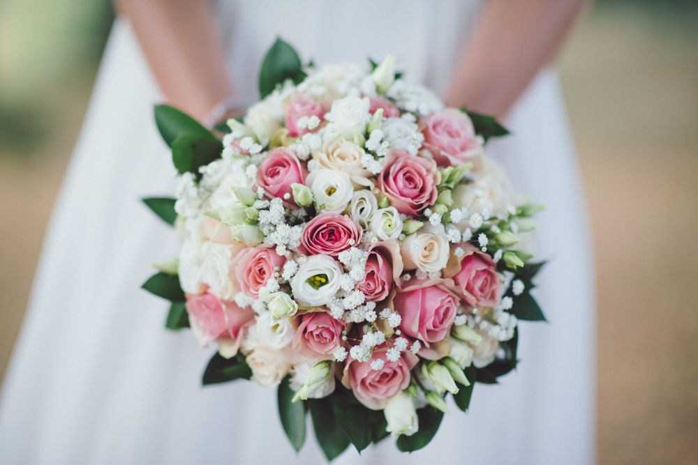 Beautiful wedding bouquet with pink and white roses and delicate floral arrangements.