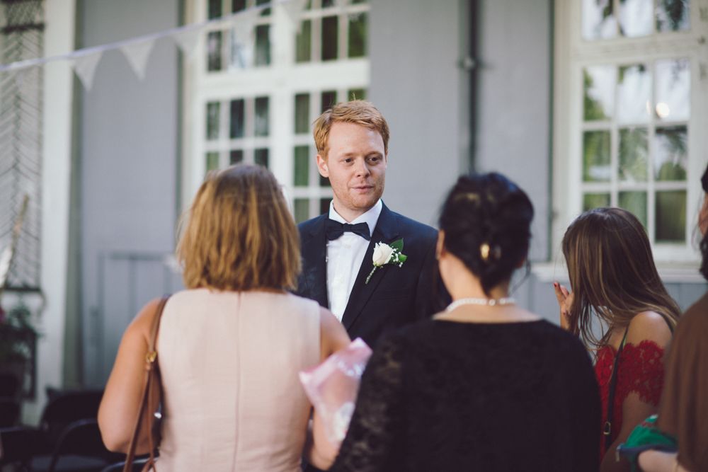 Wedding guests gather around during an outdoor celebration.