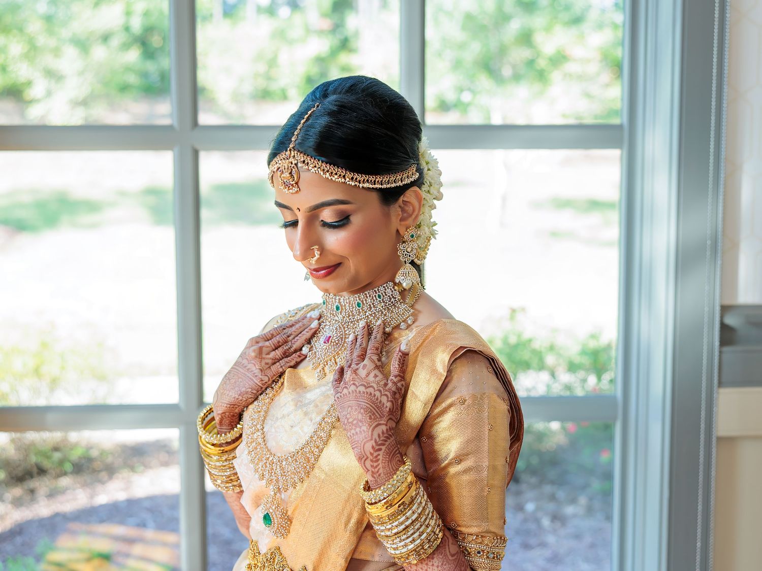 Elegant bridal portrait featuring traditional South Indian wedding attire and jewelry.