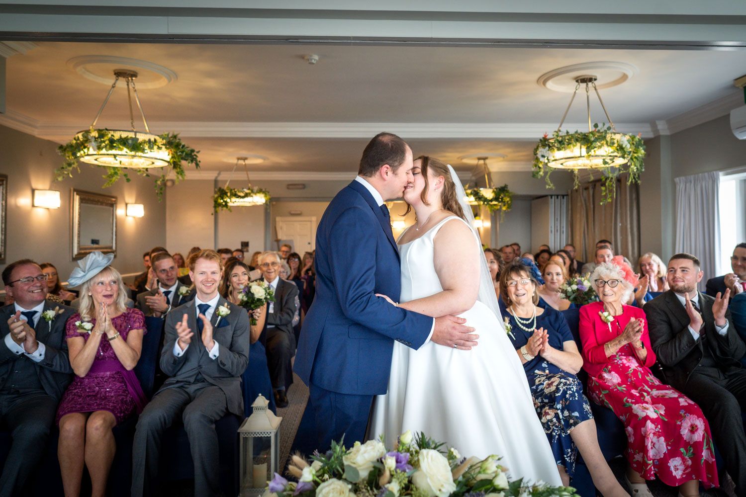 Wedding guests cheer and applaud during a ceremony at Christchurch Harbour hotel