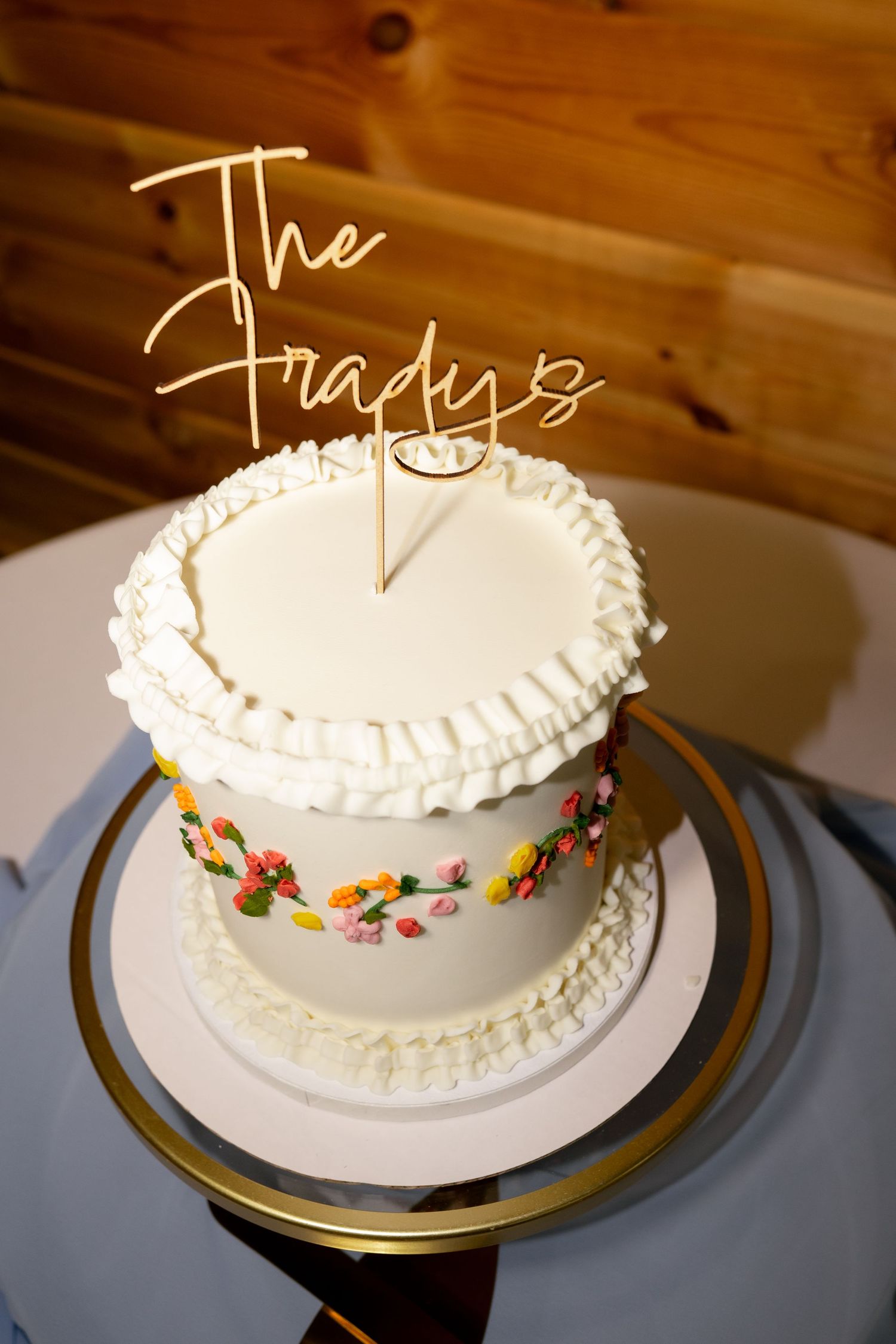 Elegant white wedding cake with floral details and gold 