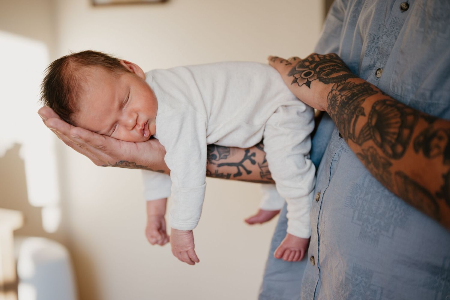 A series of tender newborn baby photos showing tiny feet and hands being held by parents in soft natural light.
