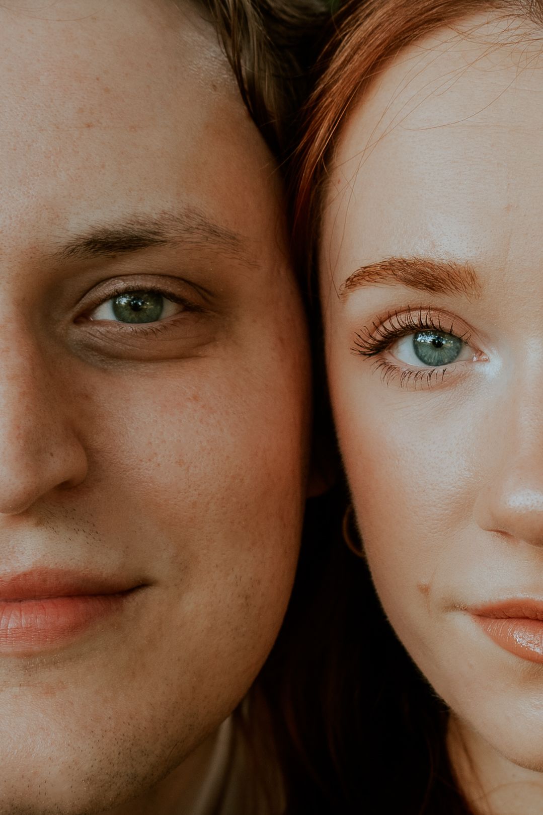 Artistic macro portrait of two faces side by side with contrasting lighting.