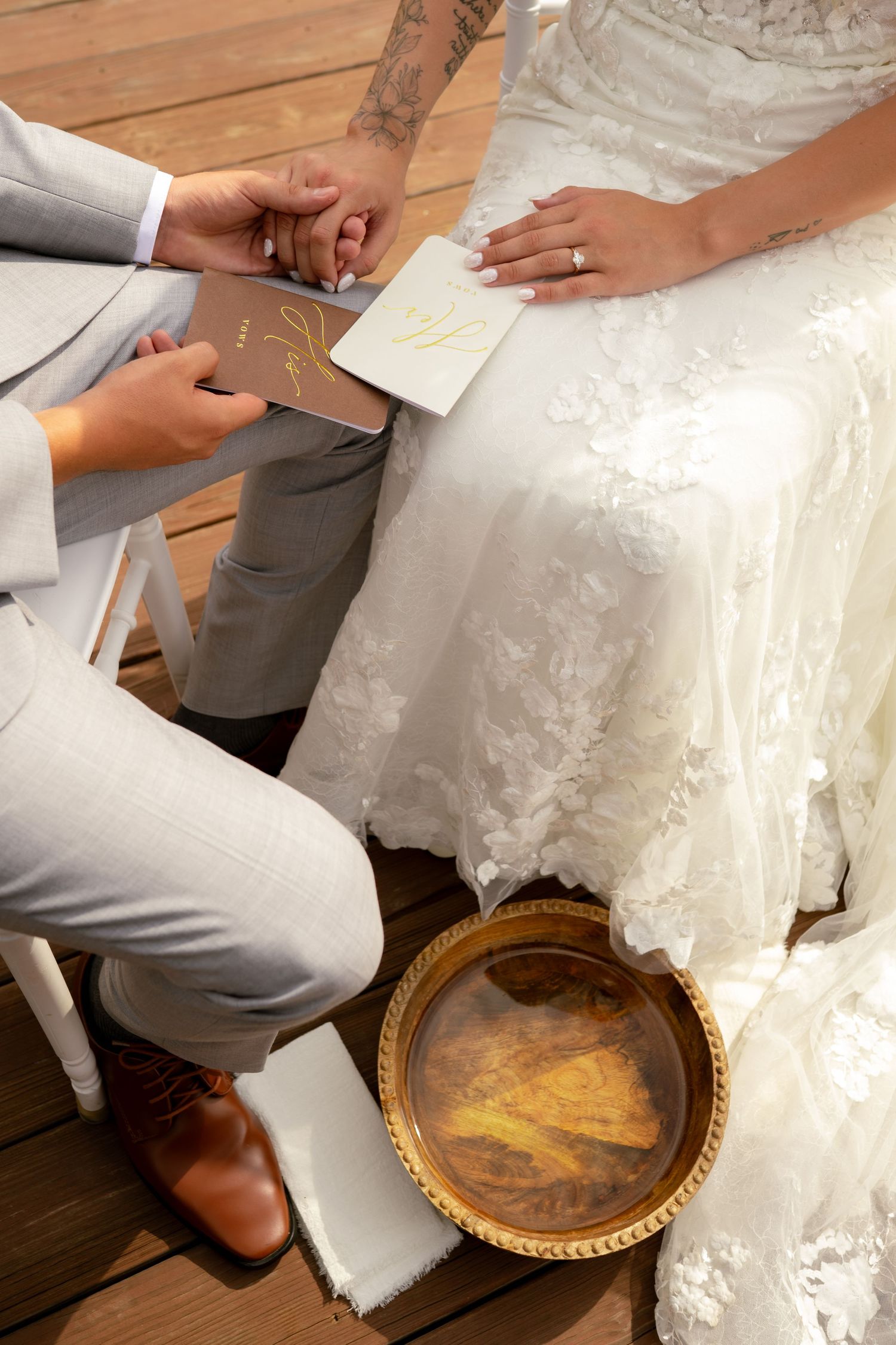 Bride and groom exchanging vows while holding hands during an intimate outdoor wedding ceremony.
