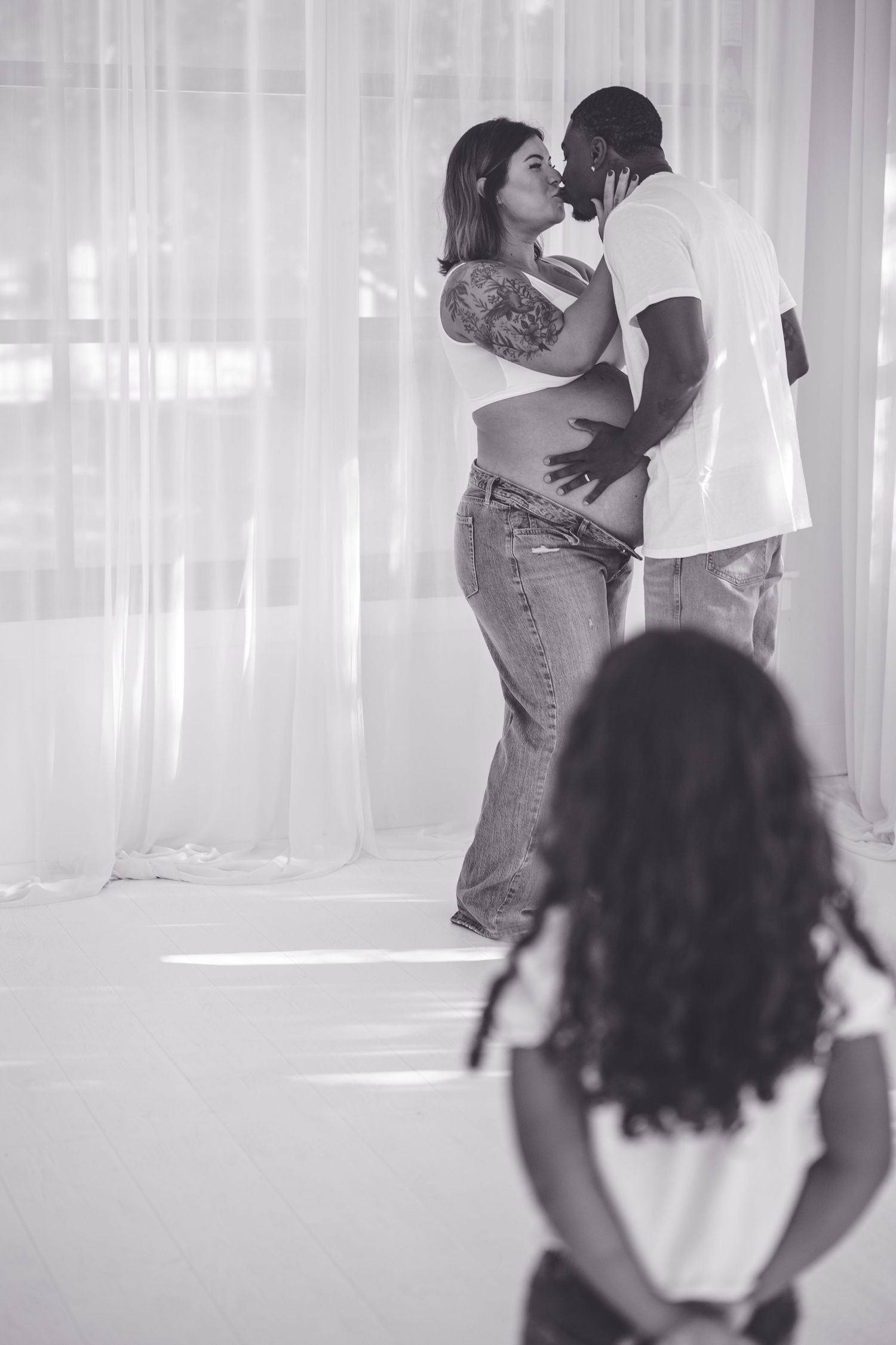 A family embracing a new member of the family, Maternity studio with child.