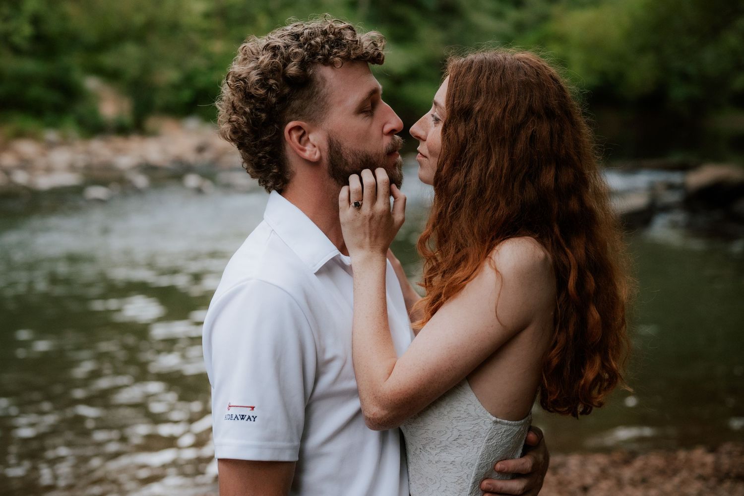 A romantic moment between two people by a forest stream.