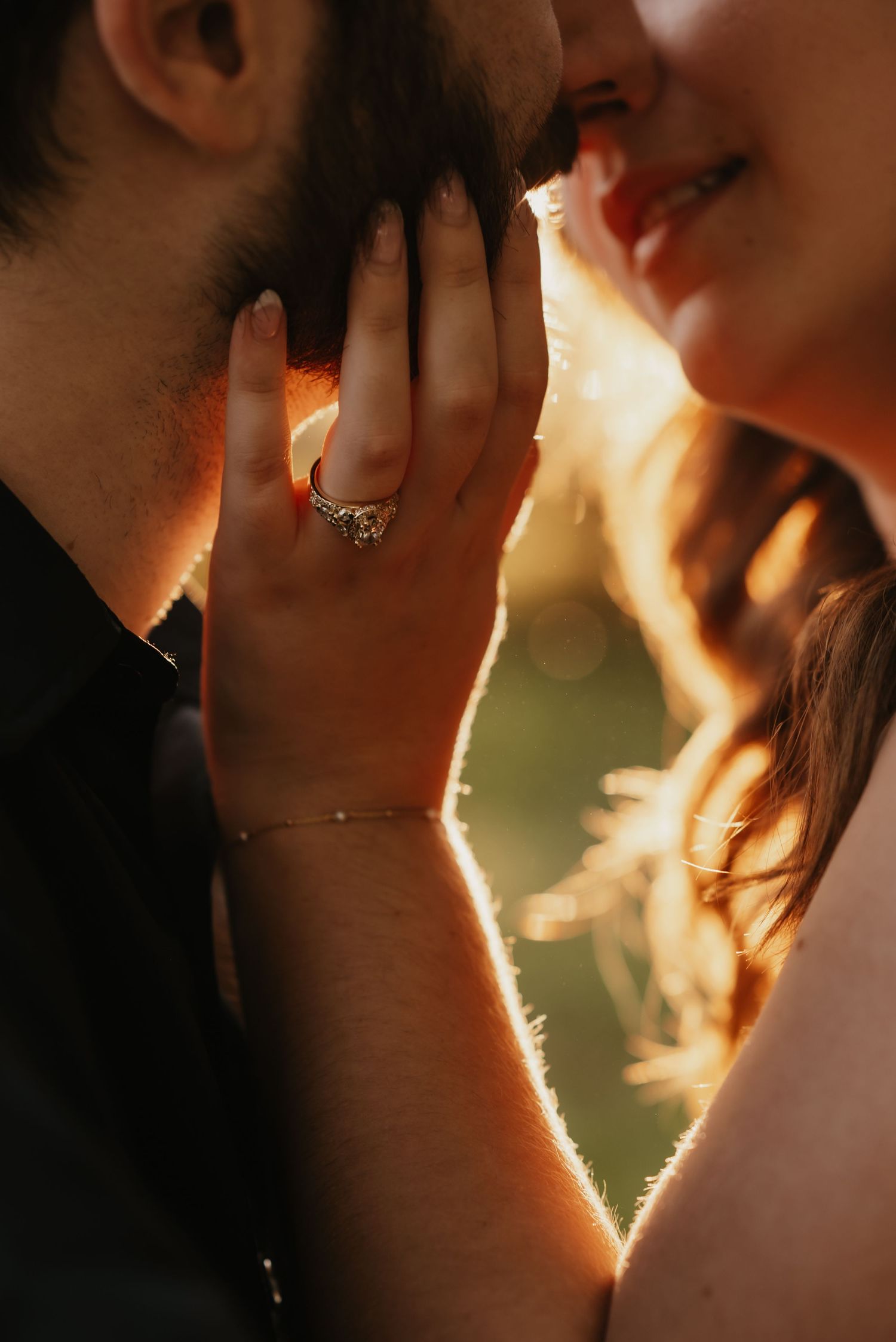 A close-up shot showing a sparkling engagement ring with golden sunlight streaming through.