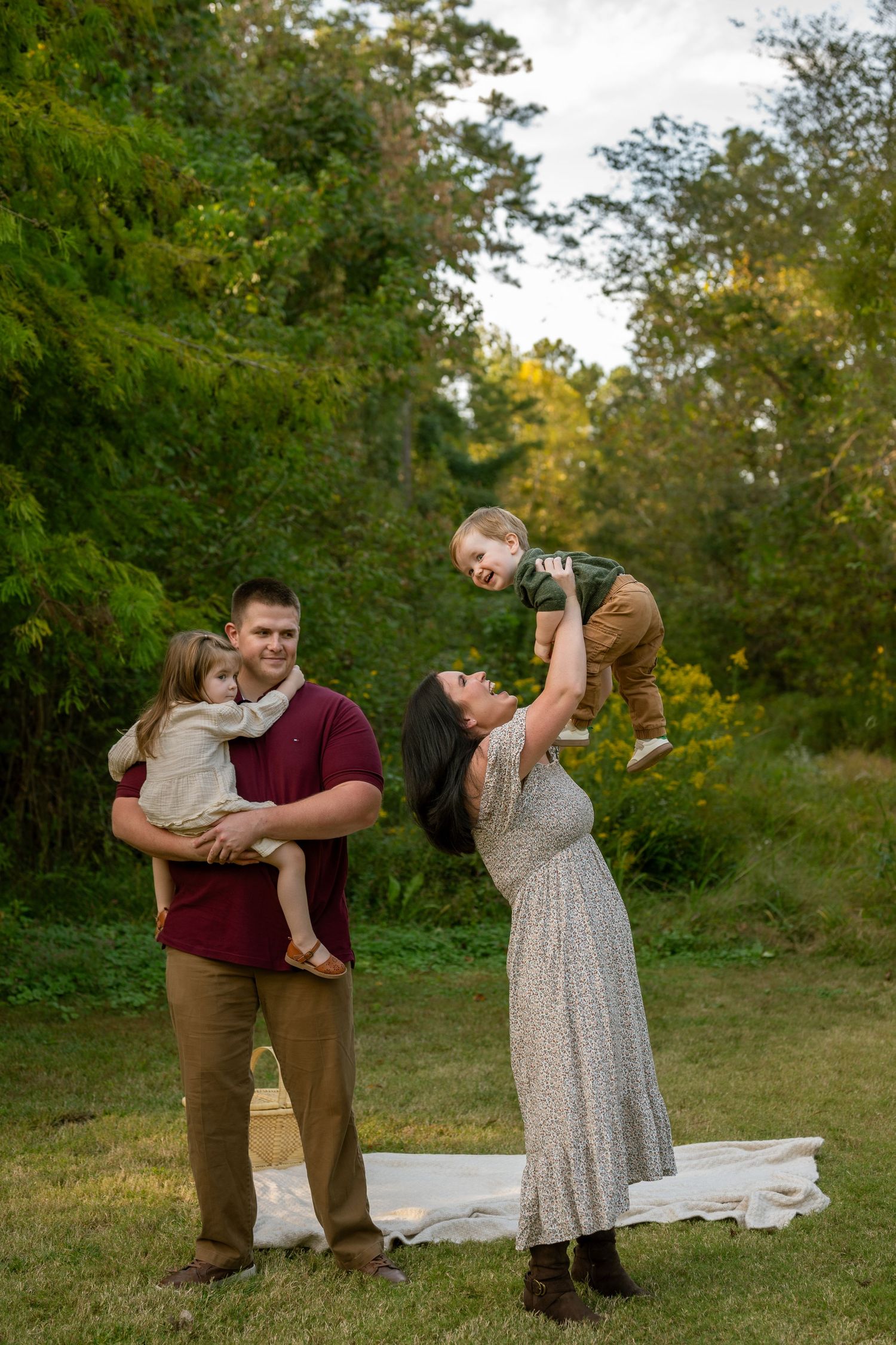 A couple shares intimate moments in a series of outdoor photos wearing burgundy and neutral fall-toned outfits.