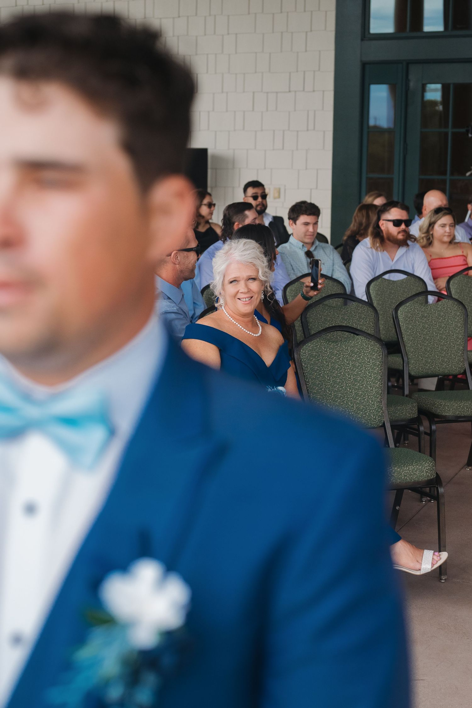 A proud mama watching her little boy get married located at River landing in Wallace, North Carolina.