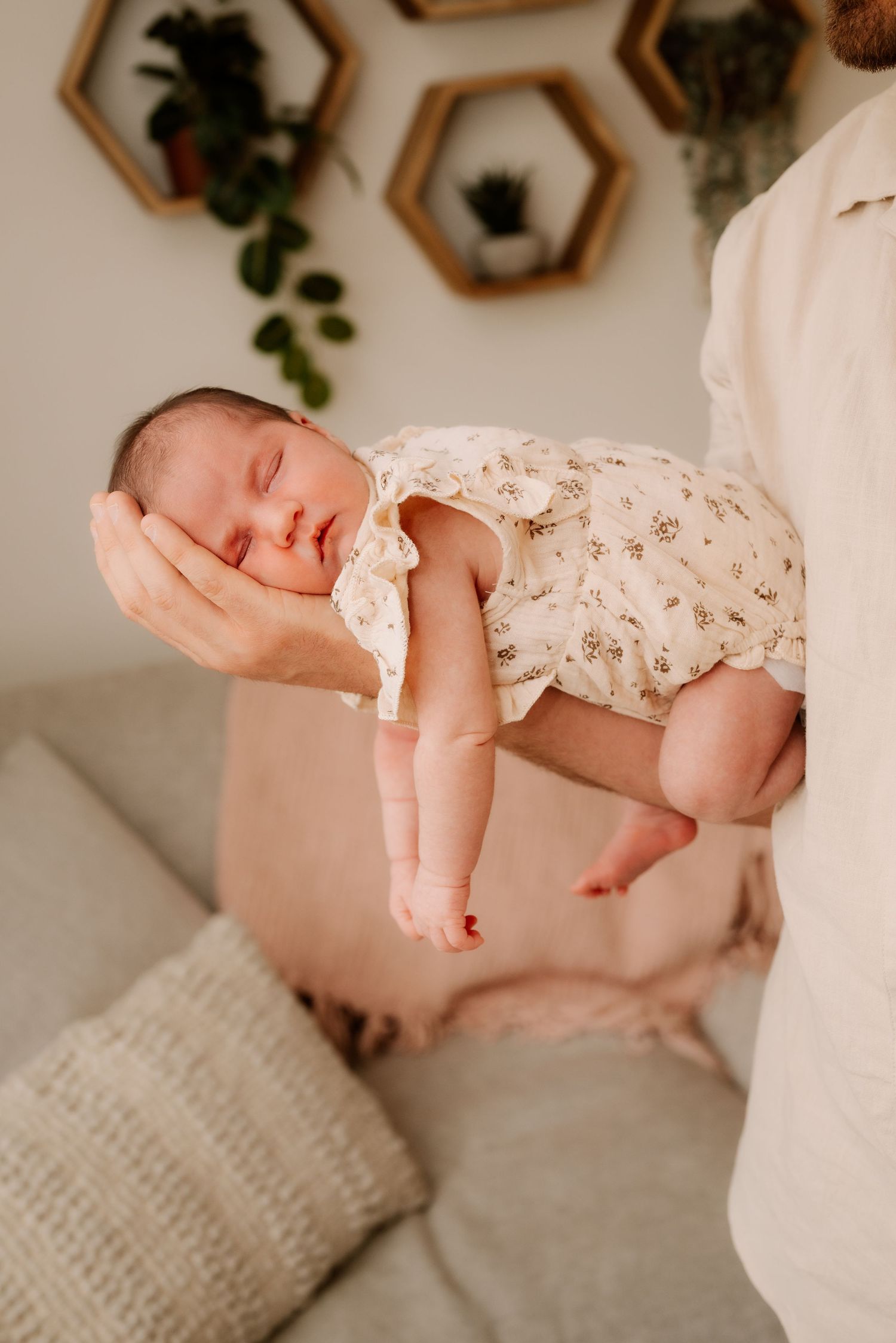 A series of close-up shots showing a sleeping baby's hands and arms against a soft white background.