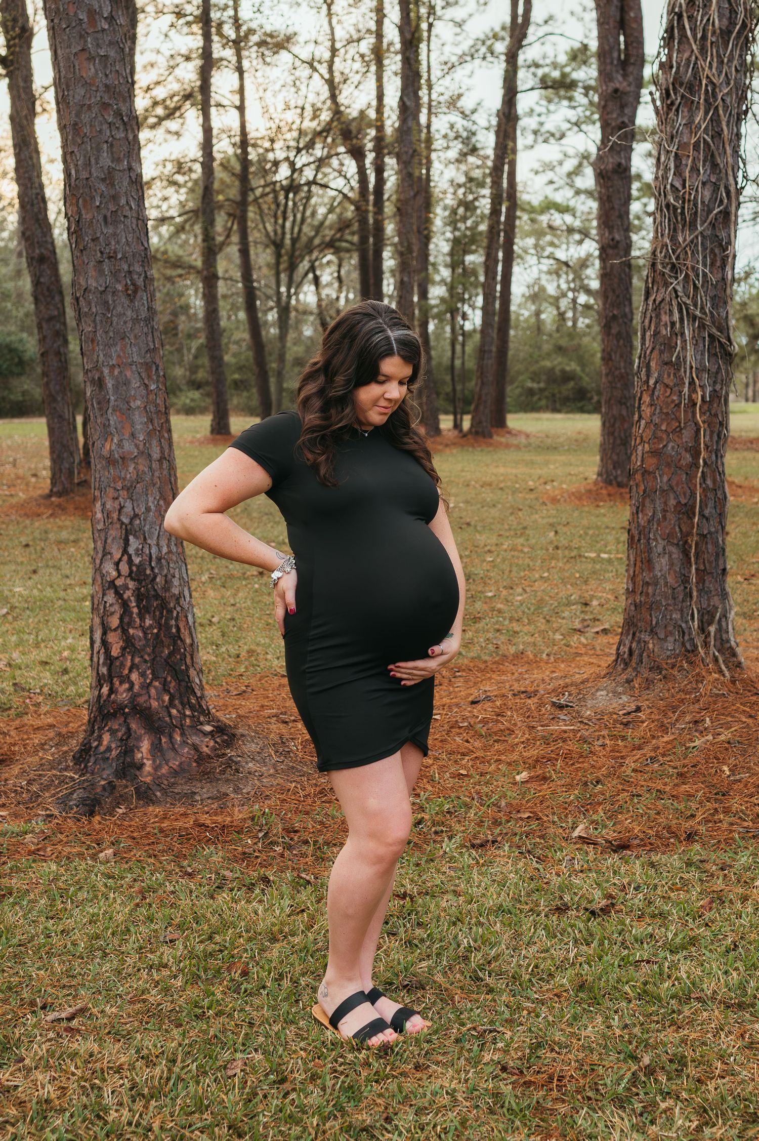 A mother to be embraces her growing belly, anxious to meet her little one