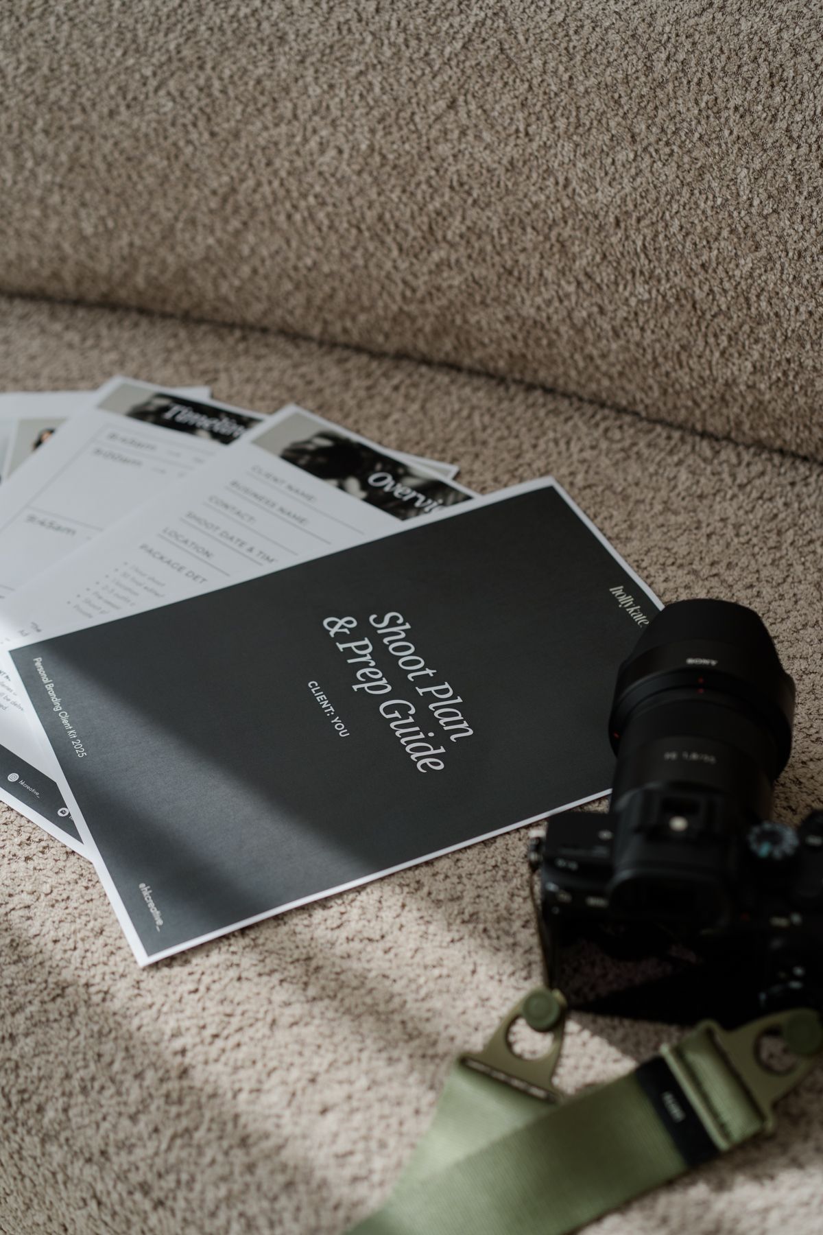 Sony camera and shoot prep guide documents resting on beige sofa with natural lighting.