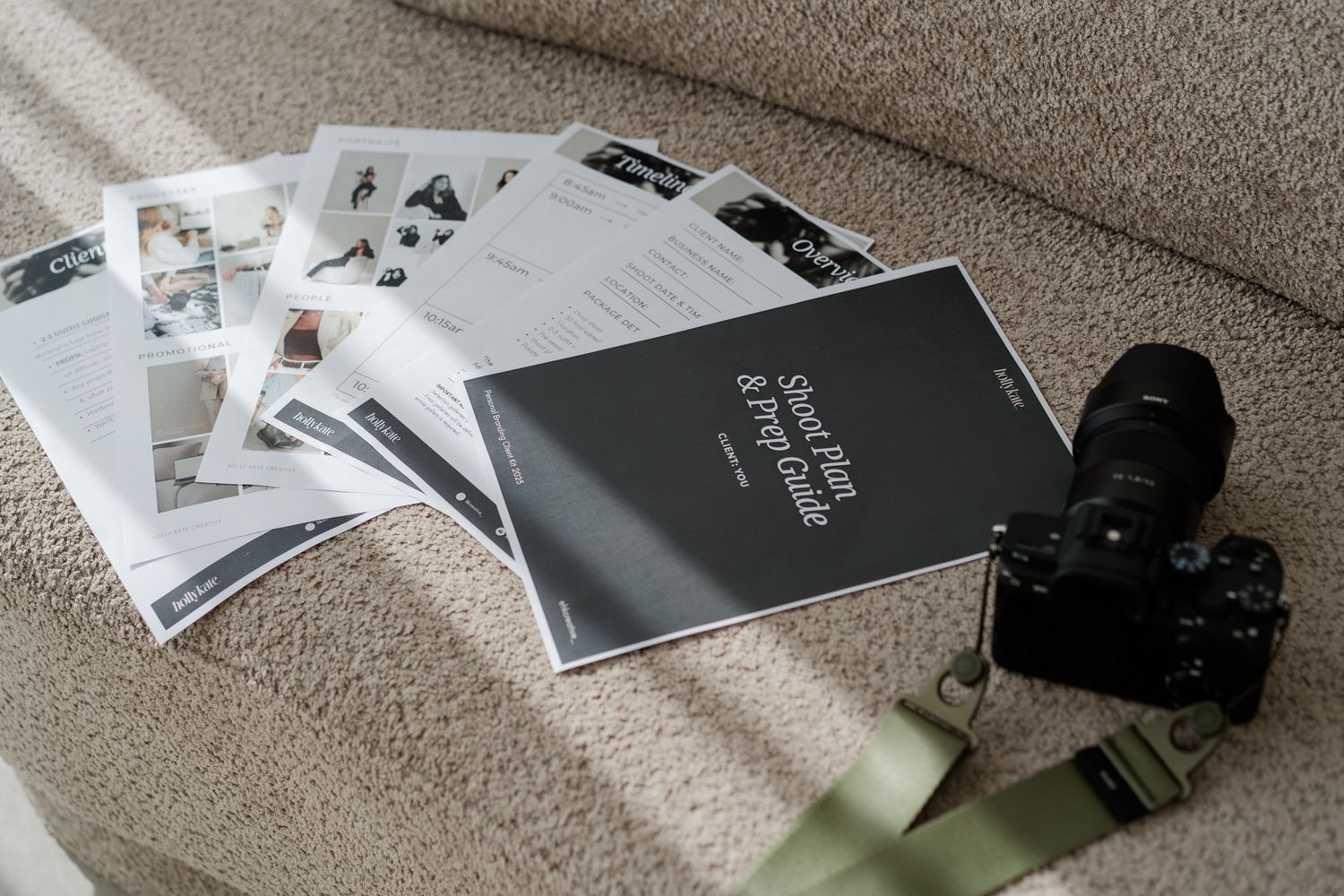 Camera and photography style guide documents laid on a textured beige sofa.