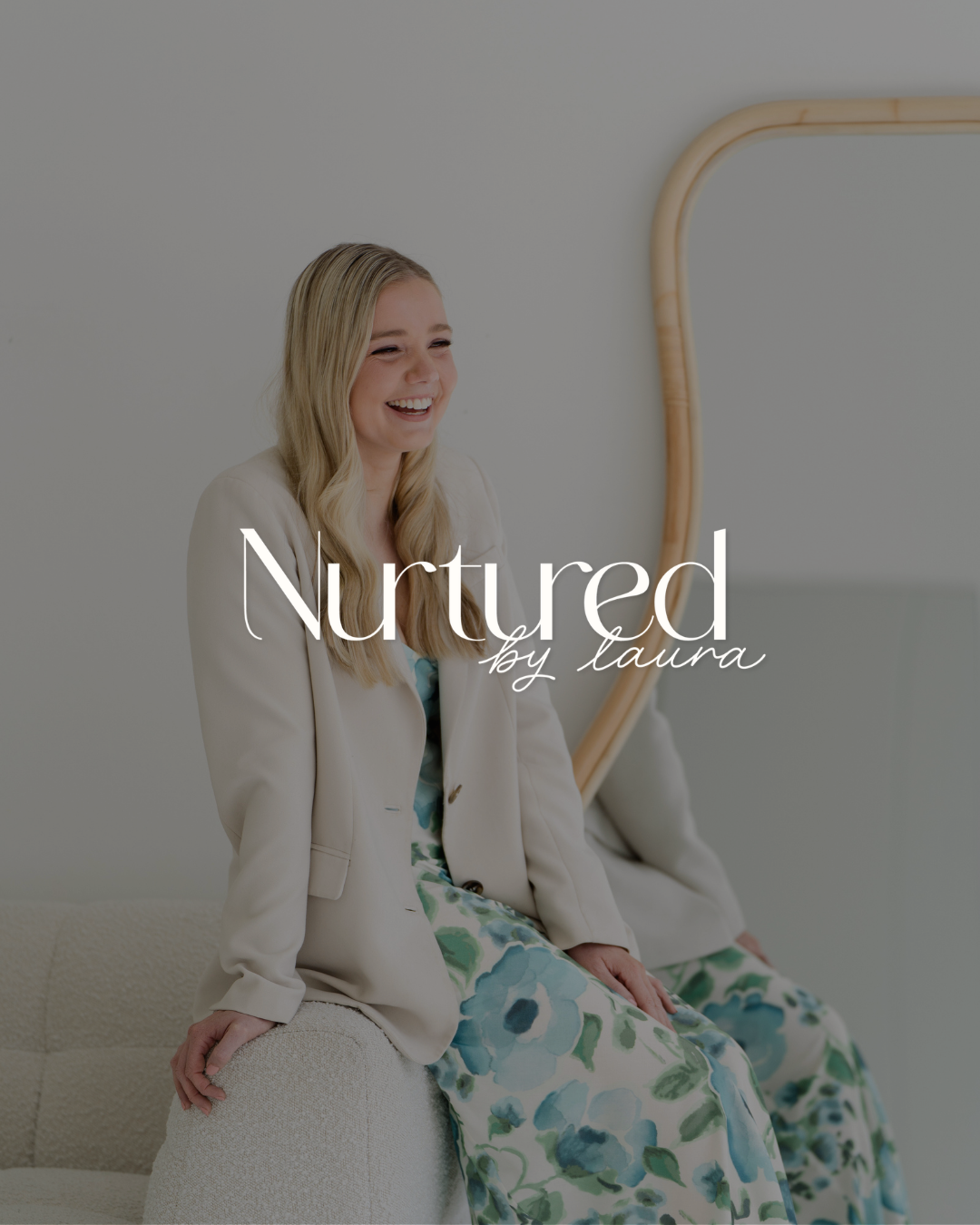 Smiling blonde woman seated wearing floral dress with Nurtured by Laura logo overlay.