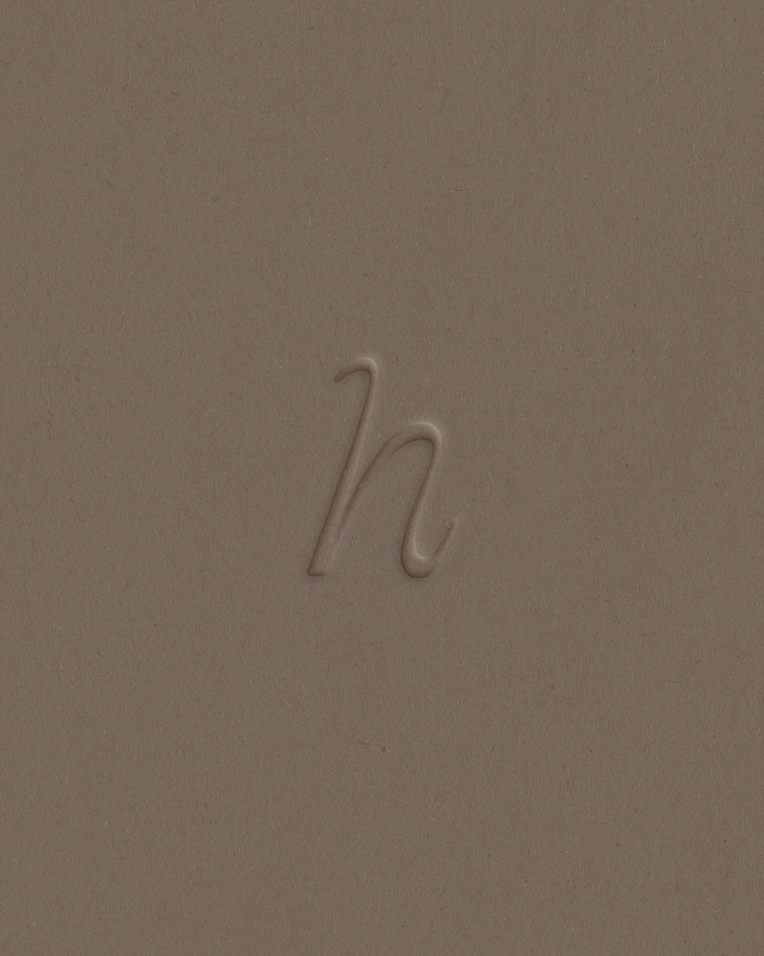 Subtle embossed lowercase h script logo on a warm taupe textured background.
