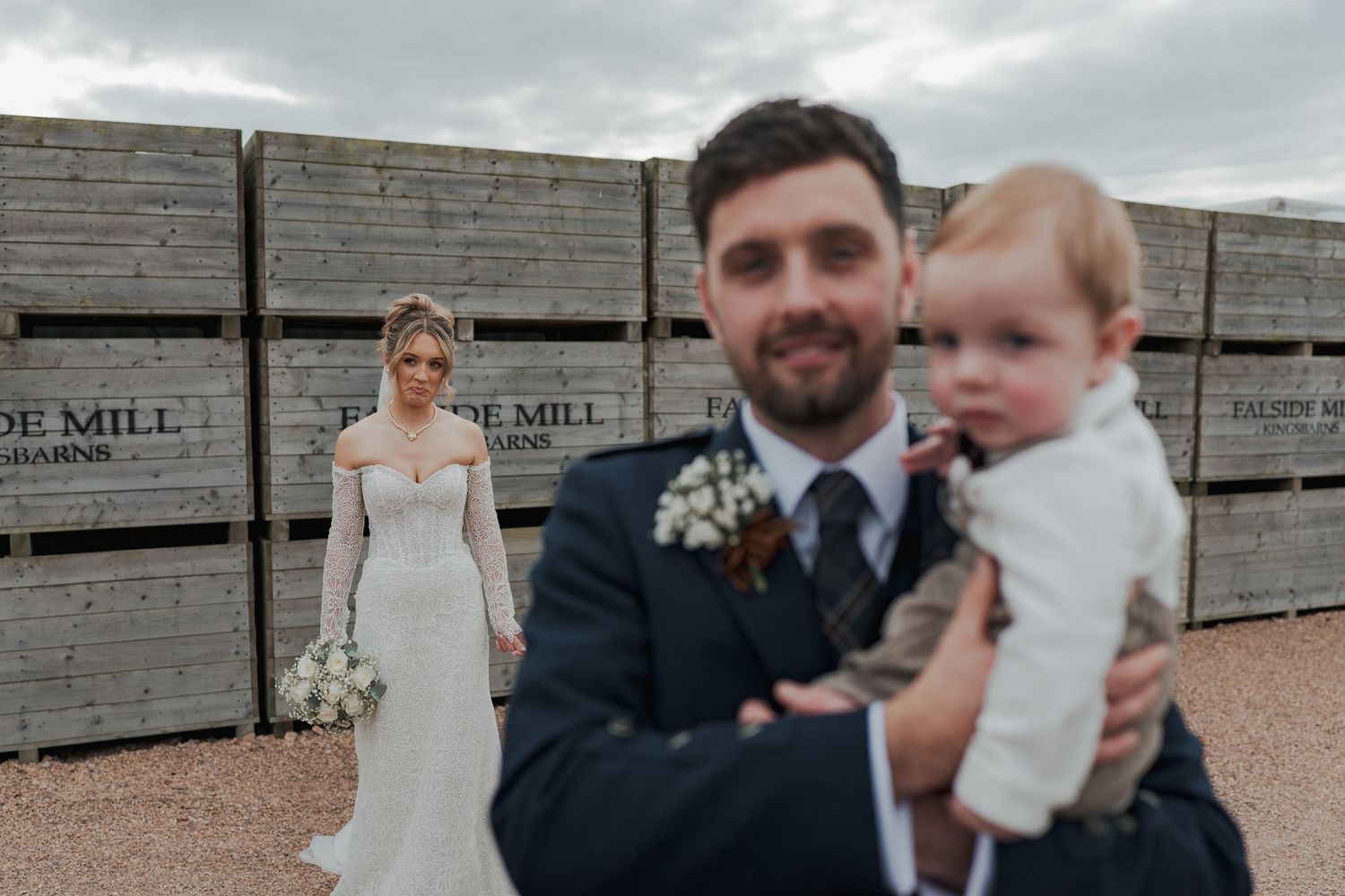 A couple shares an intimate moment during their wedding celebration at Falside Mill.