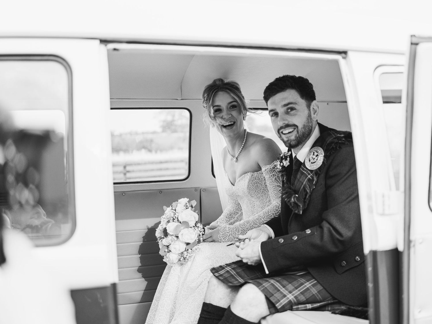 A series of black and white wedding photographs showing candid moments inside a vintage camper van.