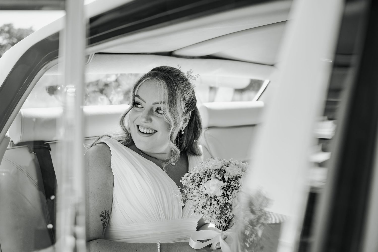 Black and white photo collage showing candid moments from a wedding celebration with joyful expressions and laughter.