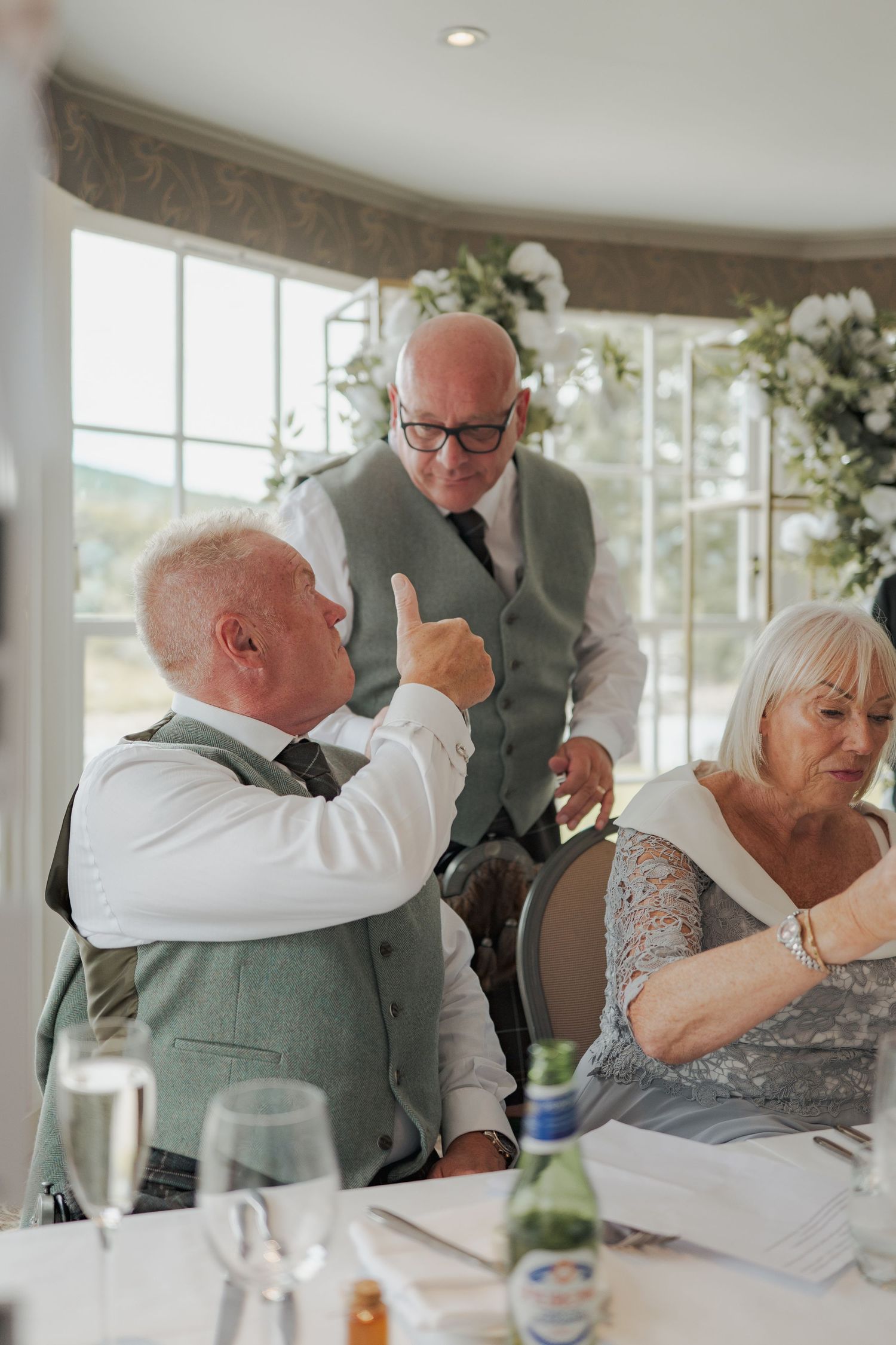 A series of candid reception photos showing heartfelt emotional moments between wedding guests during a celebration.