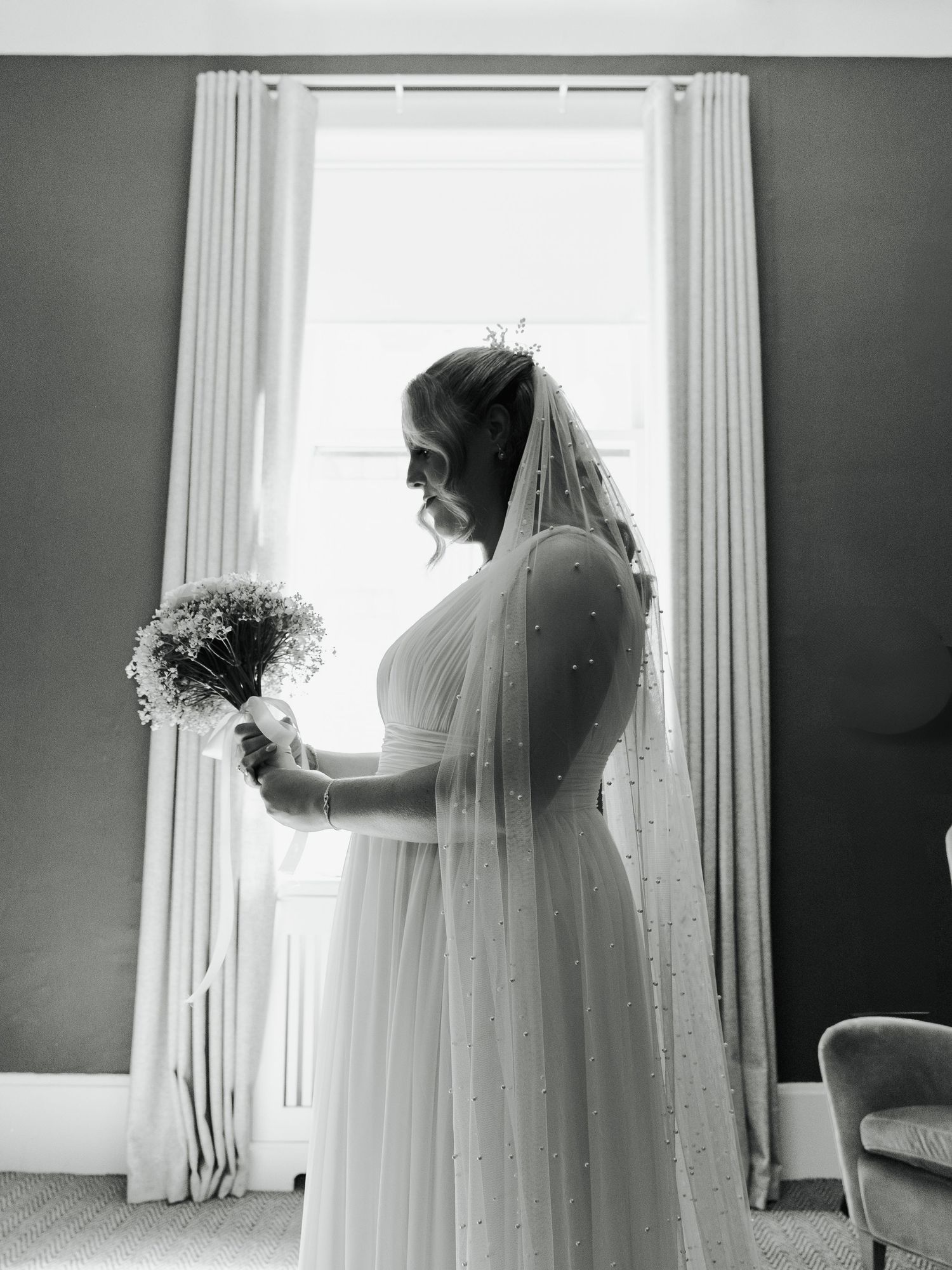 A bride in a flowing white wedding dress and veil stands silhouetted against bright windows in a series of photos.