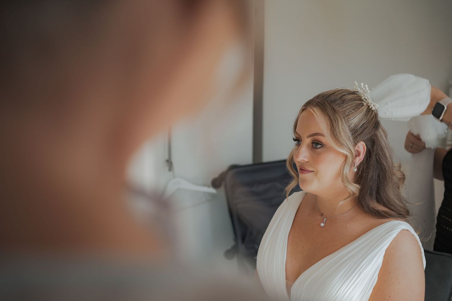 A wedding party prepares for the ceremony with final touches to their attire.