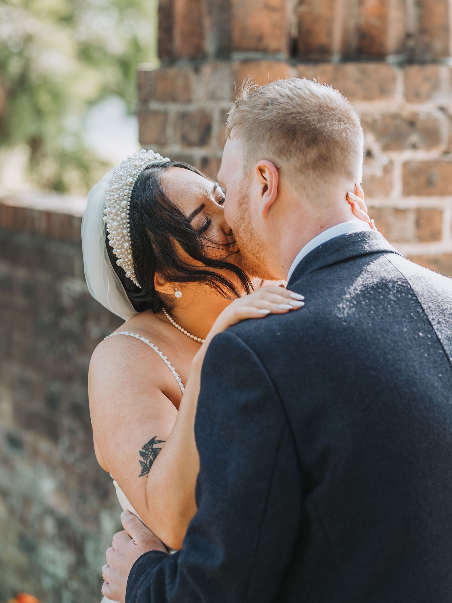 Intimate wedding couple moment against brick wall background at Oswald House, Kirkcauldy.