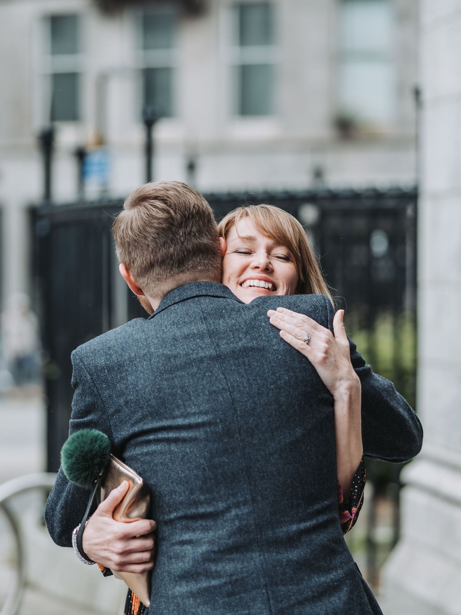 A candid moment of a couple embracing during their wedding celebration.