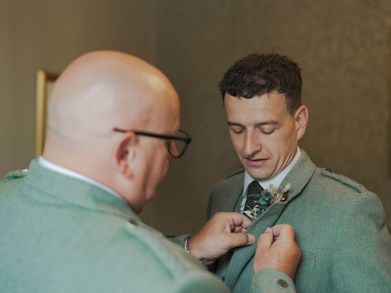 Five sequential photos show a close-up view of someone attaching a bow tie in a formal setting.