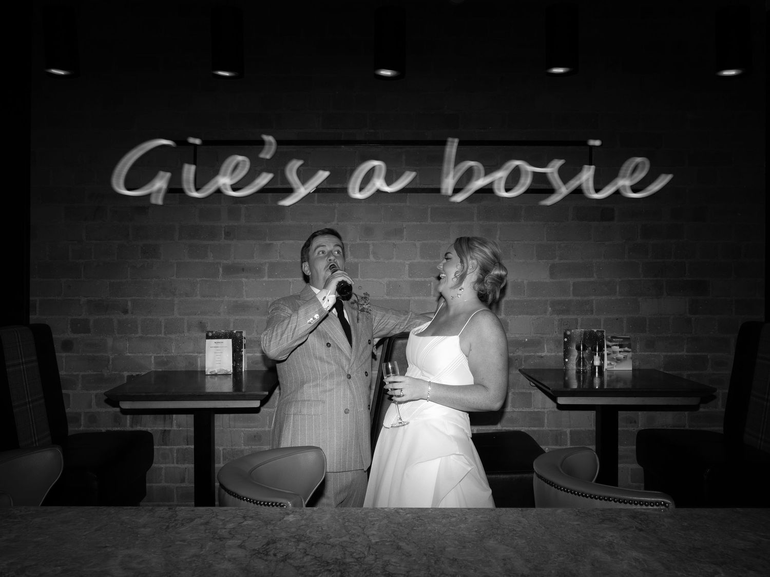 A black and white photo montage shows a couple dancing together in various romantic poses at a wedding reception.