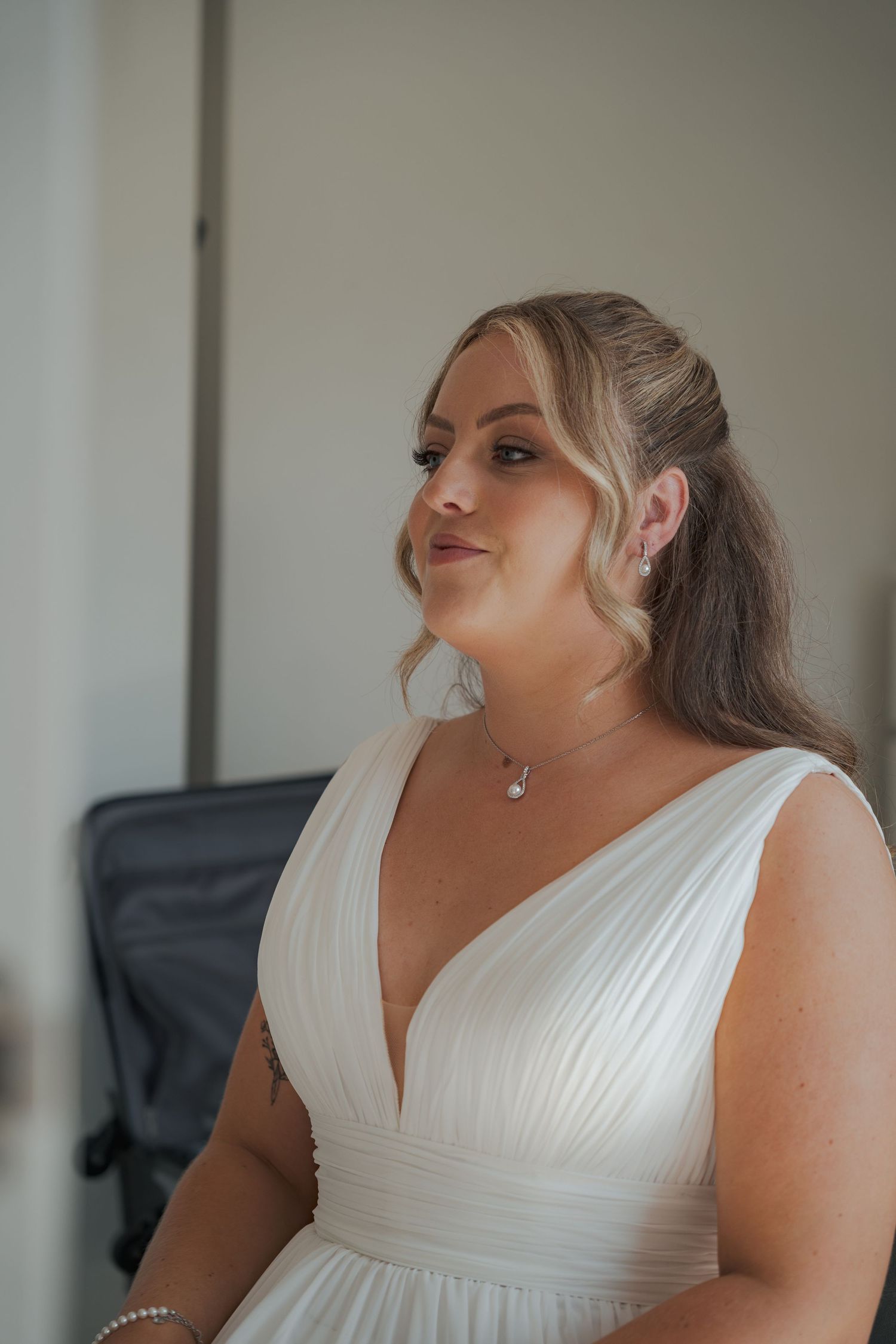 A series of four photos showing a person in a white sleeveless wedding dress posing against a light background.