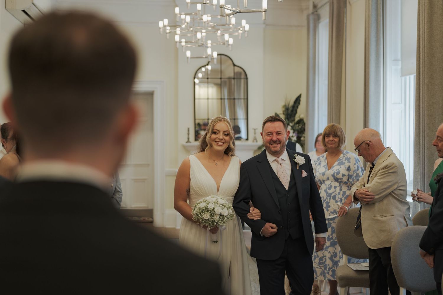 A series of candid wedding moments captured in 23 Montrose Street with white floral decorations and natural lighting.