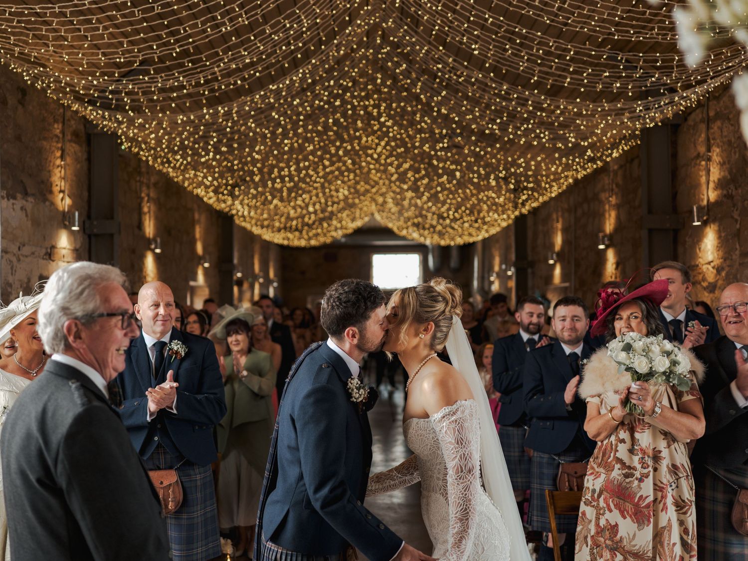 A romantic wedding celebration under a canopy of twinkling fairy lights at Falside Mill.