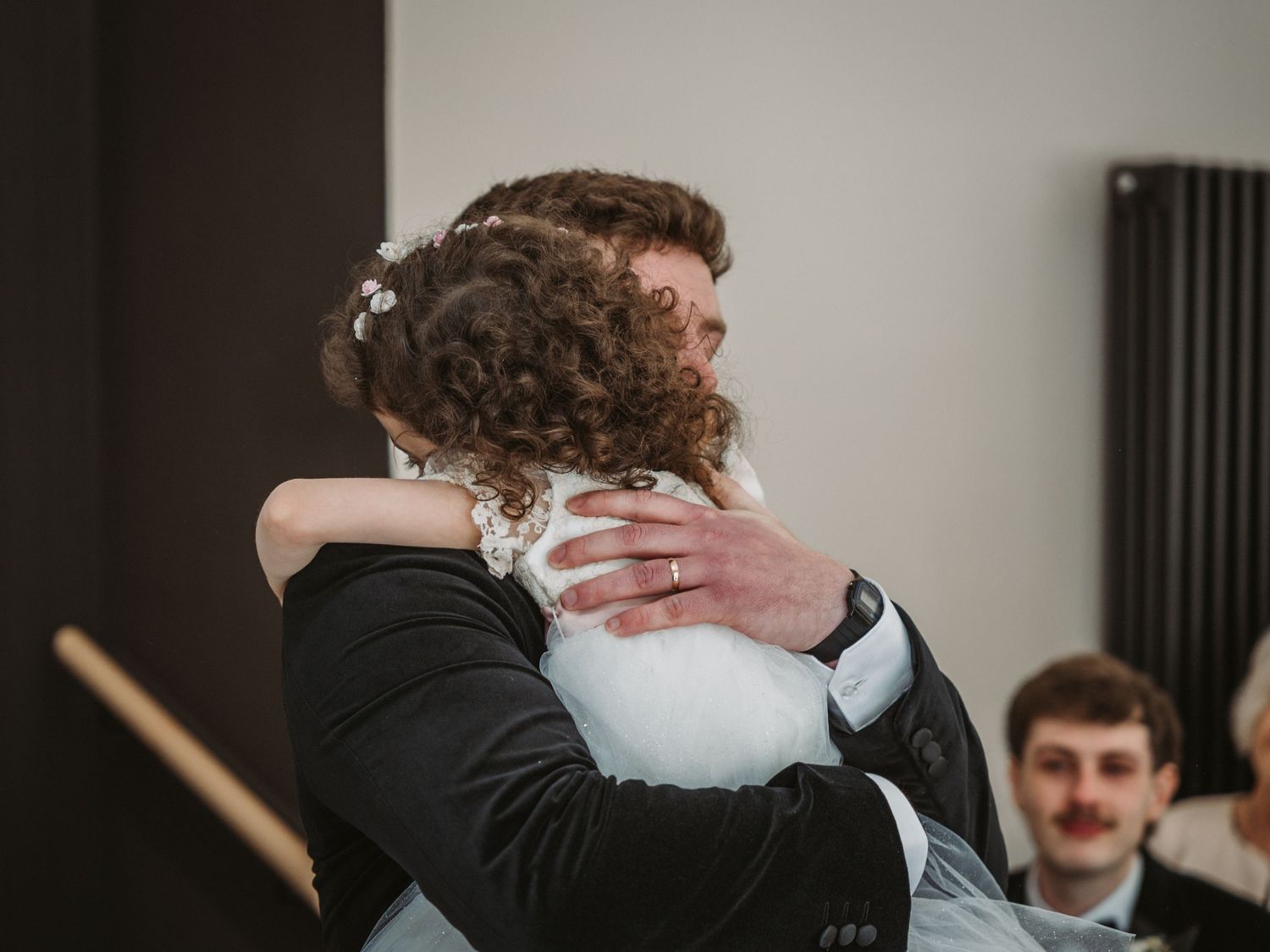 Two people share an emotional embrace at a wedding celebration at Kinclune House.