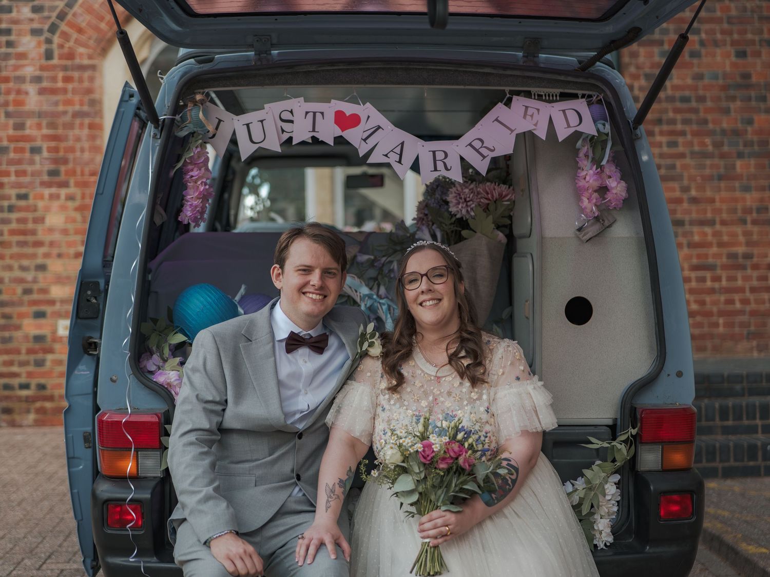 A collage of four wedding photos shows a couple's special moments in front of a brick building entrance.